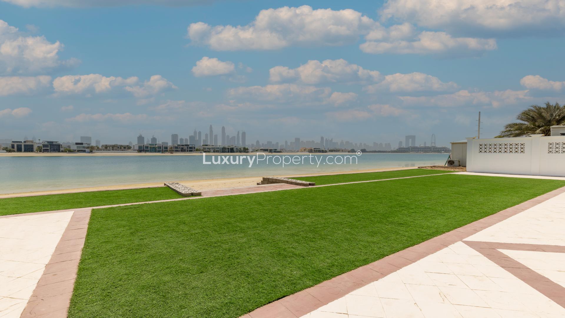 Luxurious Palm Jumeirah villa exterior, beachfront, showcasing elegant architecture and spacious design