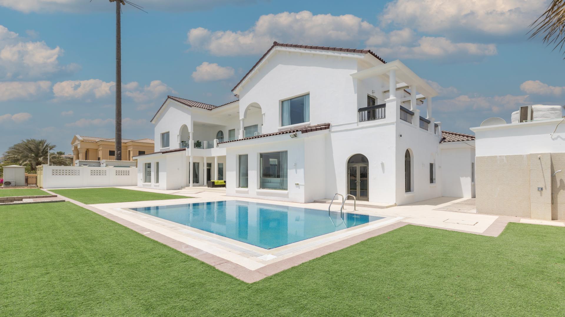 Alt text: "Palm Jumeirah villa with marina skyline view, lush lawn, beachfront for sale",Luxurious Palm Jumeirah villa with pool, spacious lawn, and elegant architecture for sale