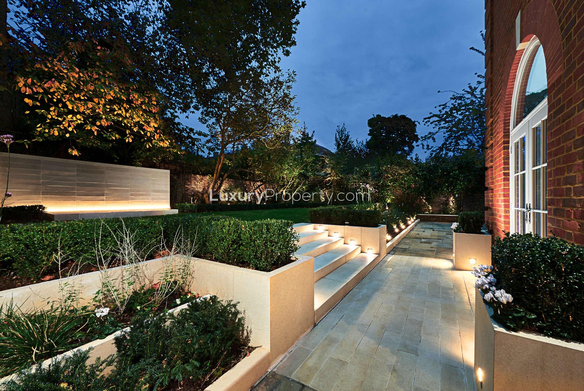 Elegant villa exterior on Acacia Road, St. John's Wood, London, with lush garden