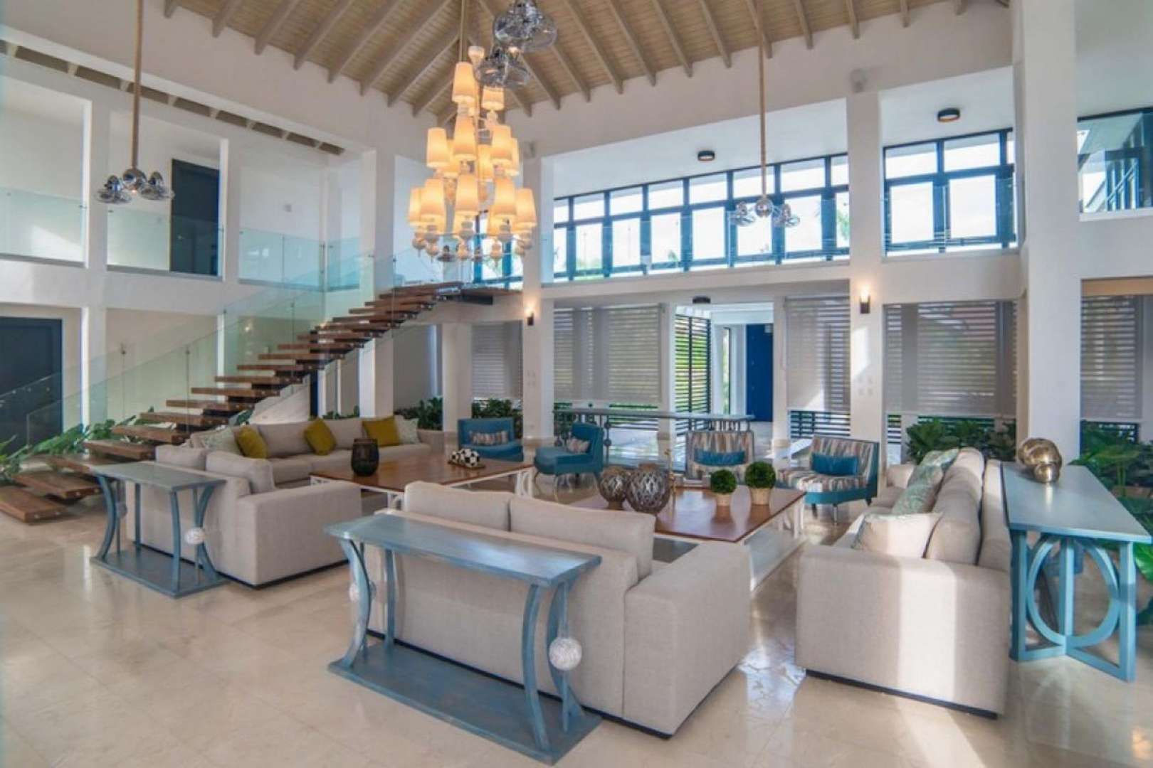 Villa for sale in Casa de Campo, La Romana with lush green lawn and palm trees