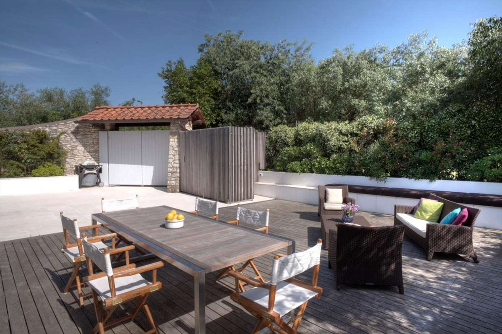 Gorgeous patio of Villa Gelsomino, Florence, surrounded by lush greenery, perfect for relaxation