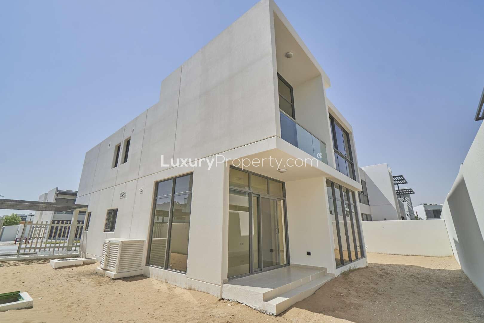 "Modern 6-bedroom villa exterior in Damac Hills 2, Akoya Zinnia, with driveway and greenery.",Exterior view of modern 6-bedroom villa in Damac Hills 2, Akoya Zinnia community