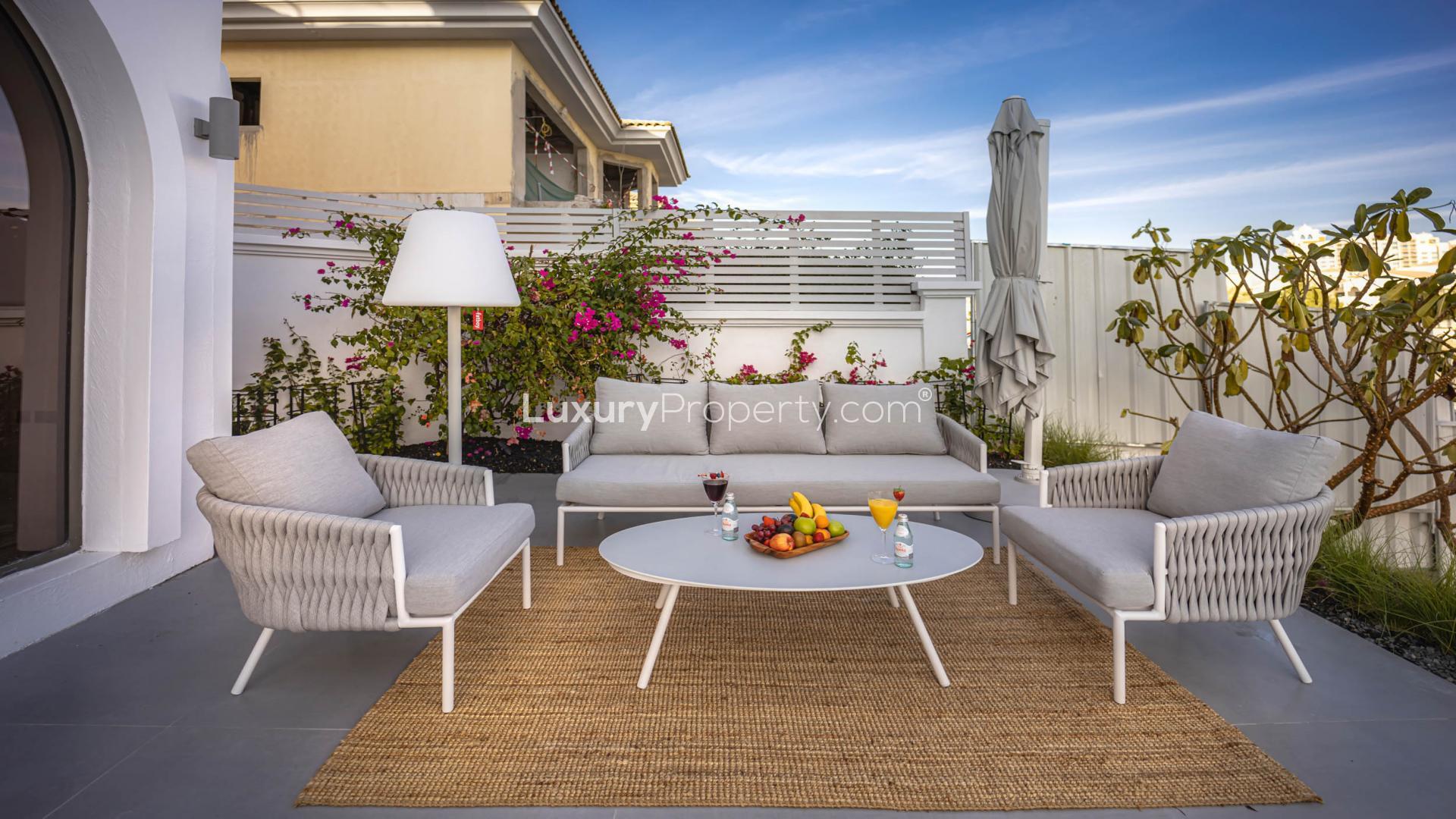 Luxurious living room in six-bedroom villa, Palm Jumeirah, with elegant decor and natural light