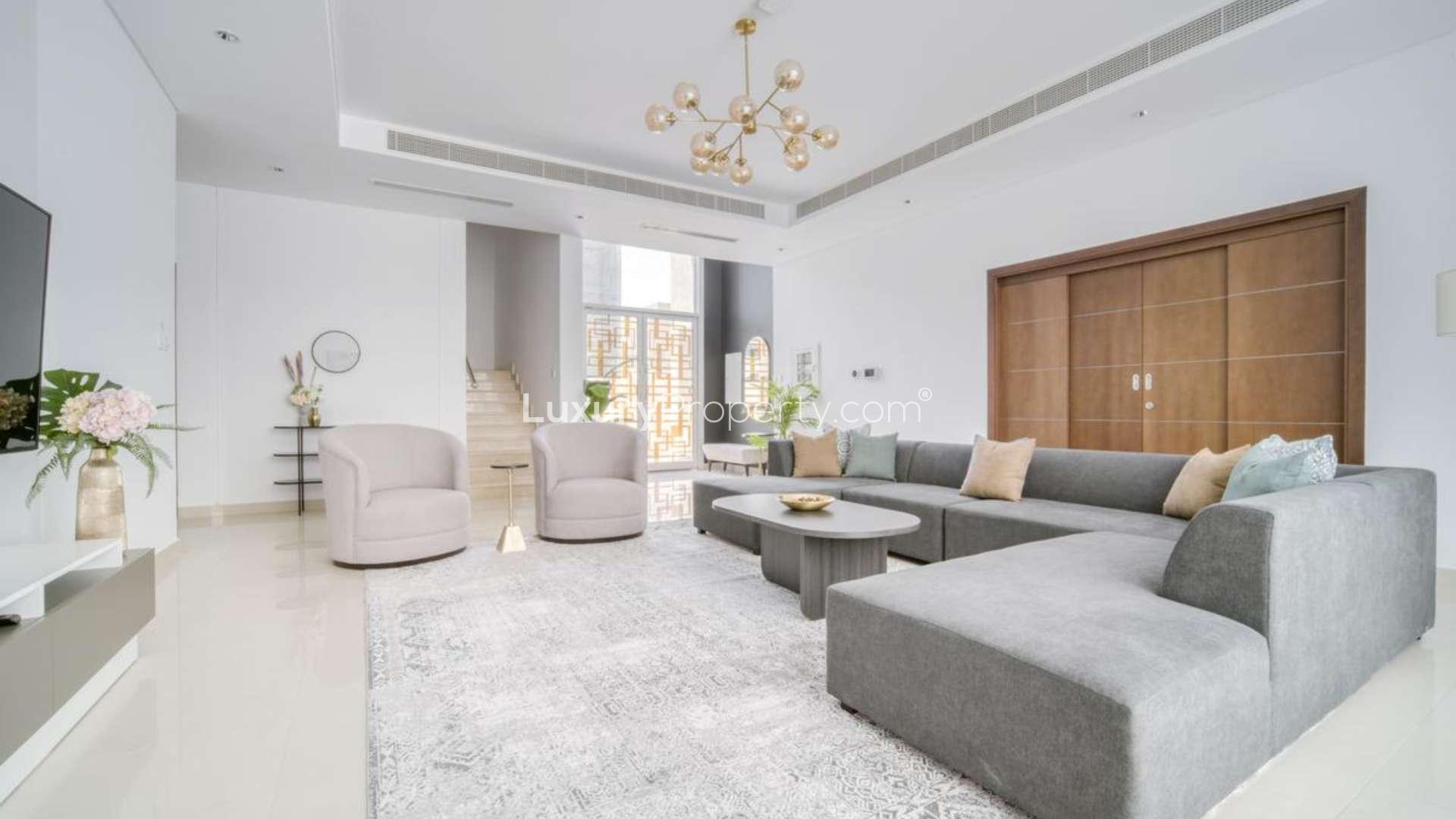 Luxurious villa pool area with sun loungers and seating, Umm Suqeim 2, Dubai