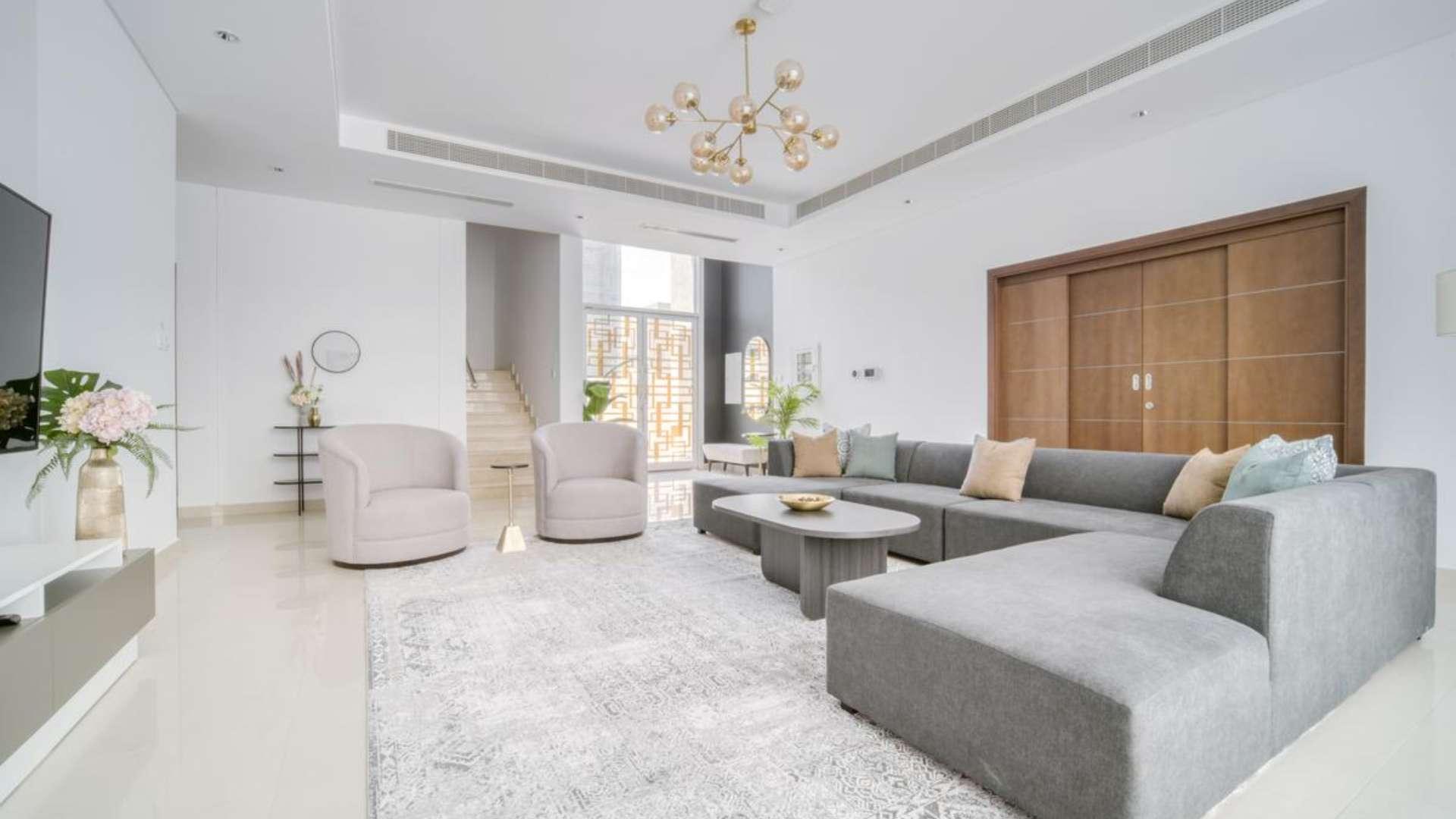 Luxurious villa pool area with sun loungers and seating, Umm Suqeim 2, Dubai