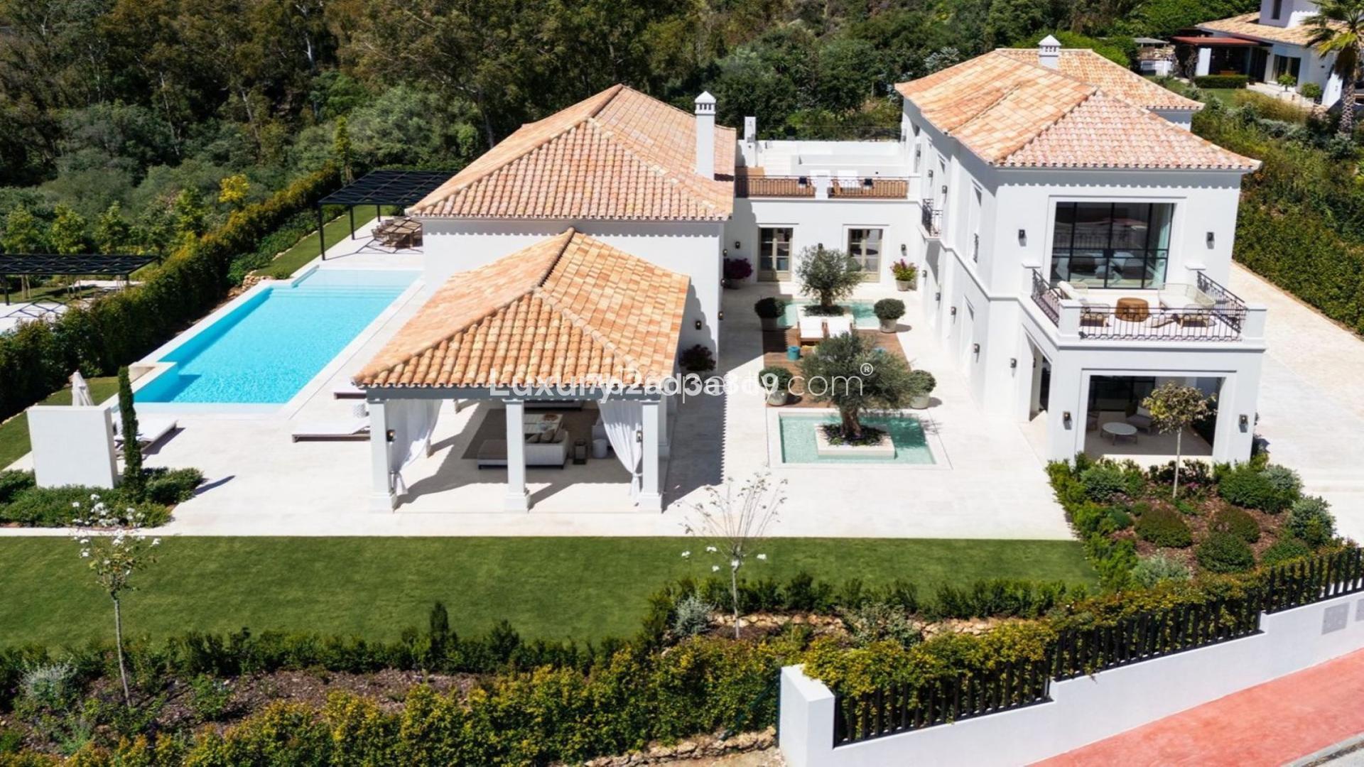 Aerial view of elegant French-inspired villa with pool in La Cerquilla, Marbella