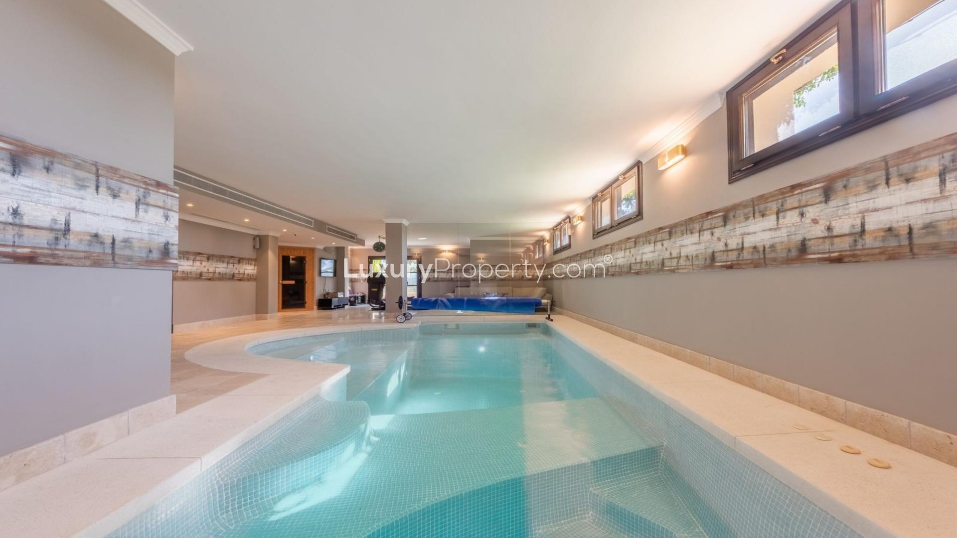"Elegant La Zagaleta villa with private pool, lush garden, and panoramic sea views.",Indoor spa pool in elegant La Zagaleta villa for sale, Málaga