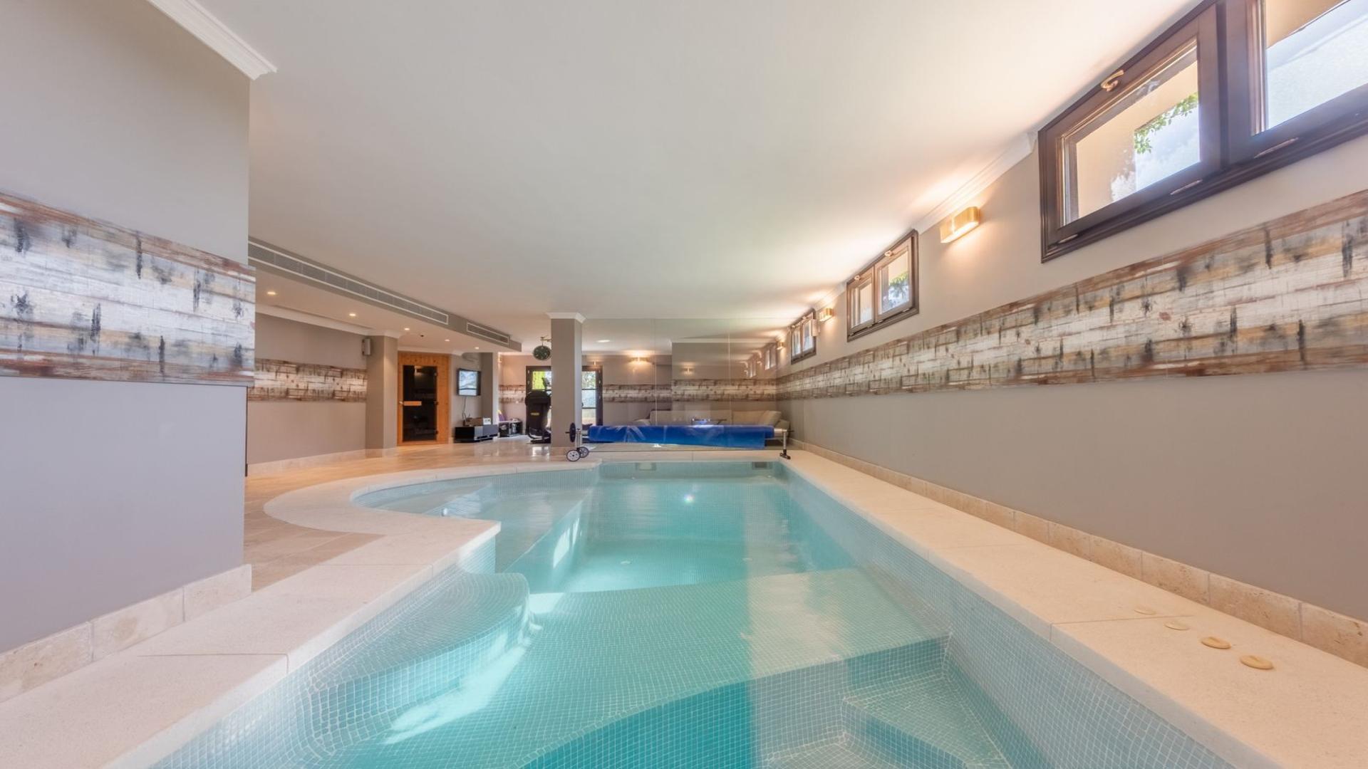"Elegant La Zagaleta villa with private pool, lush garden, and panoramic sea views.",Indoor spa pool in elegant La Zagaleta villa for sale, Málaga