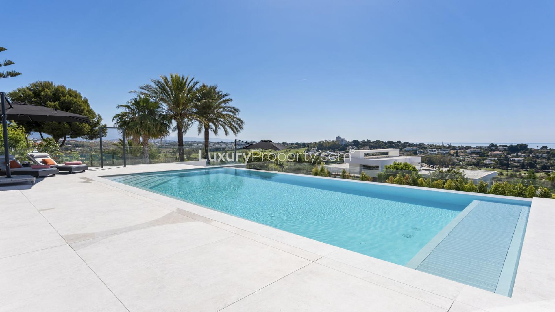 "Stunning infinity pool with panoramic views at El Paraiso villa, Málaga, for sale.",Luxurious villa pool with panoramic views in El Paraíso, Málaga, near golf club