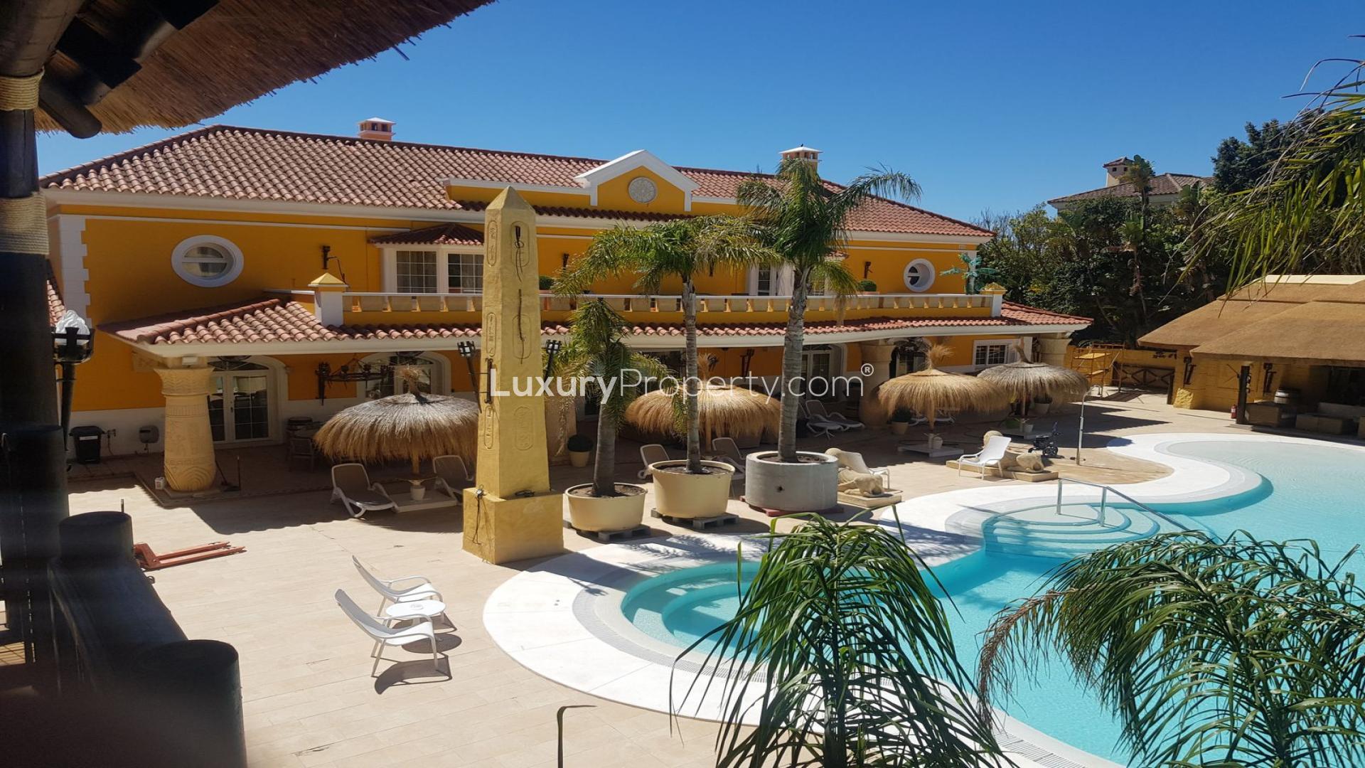 Luxurious 6-bedroom villa entrance with grand columns in Sotogrande, Cadiz, Spain at dusk