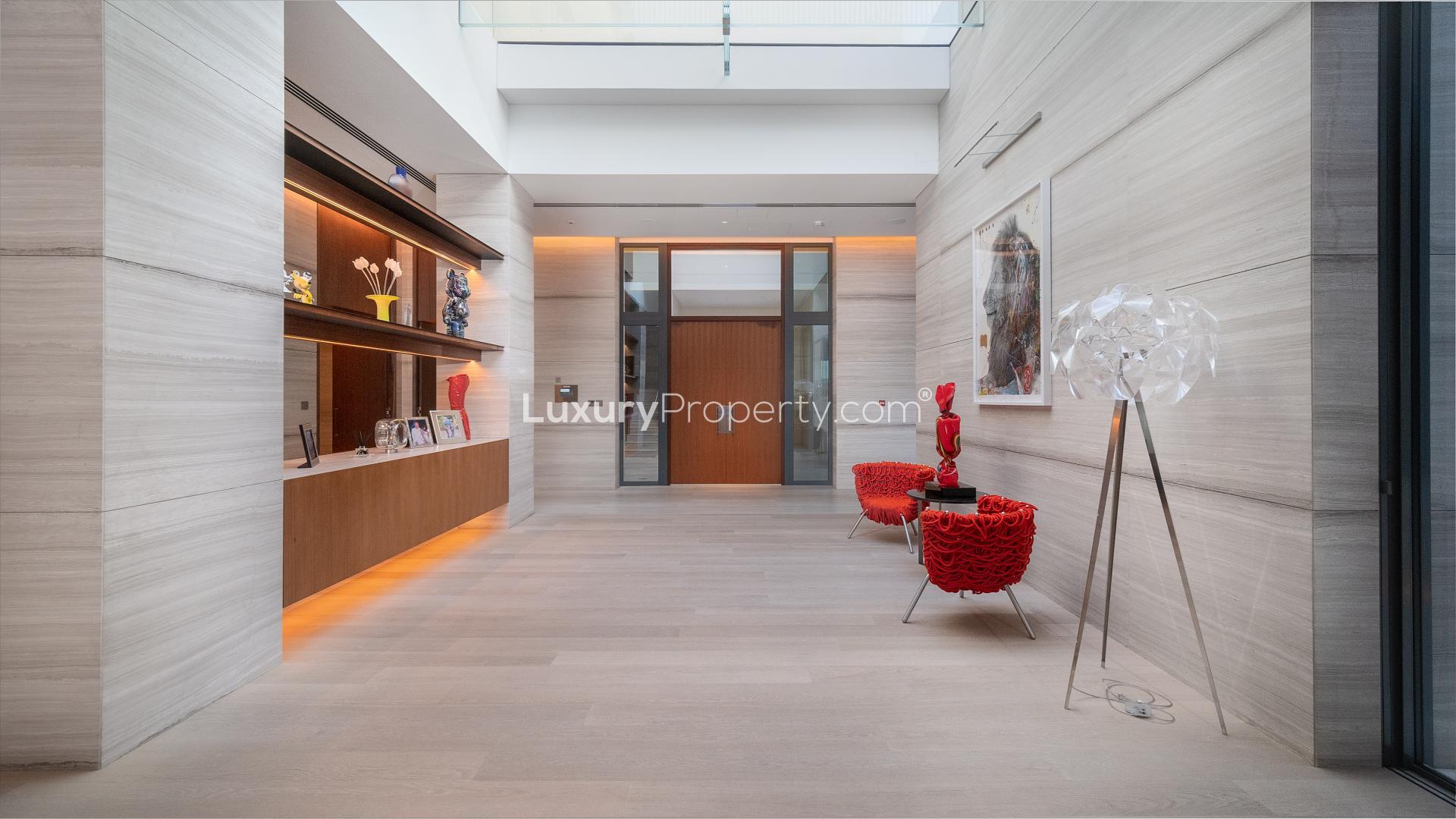 Luxurious Dubai Hills Grove villa entrance with modern architecture and landscaped garden at dusk