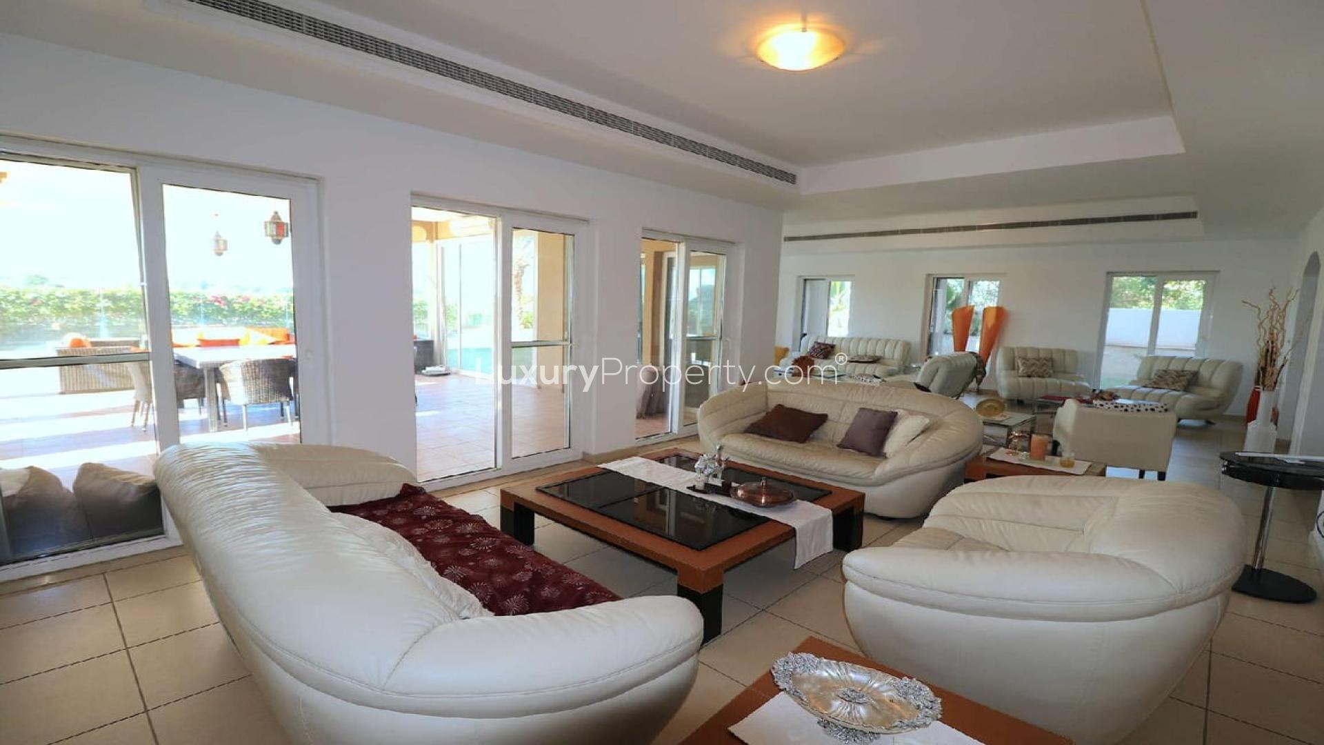 Upgraded villa exterior with palm trees in Al Mahra, Arabian Ranches for rent