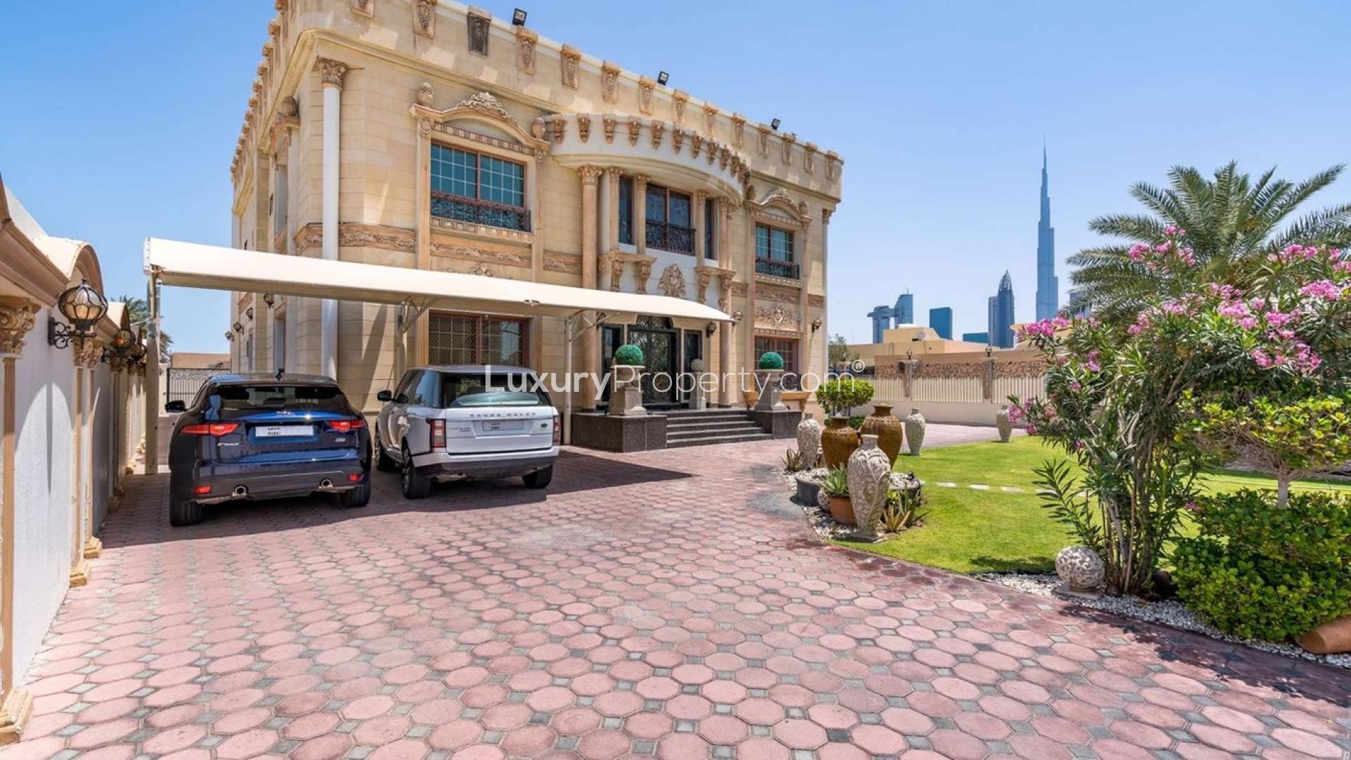 Exquisite 6-bedroom villa exterior with garden, driveway, and city view on Al Wasl Road