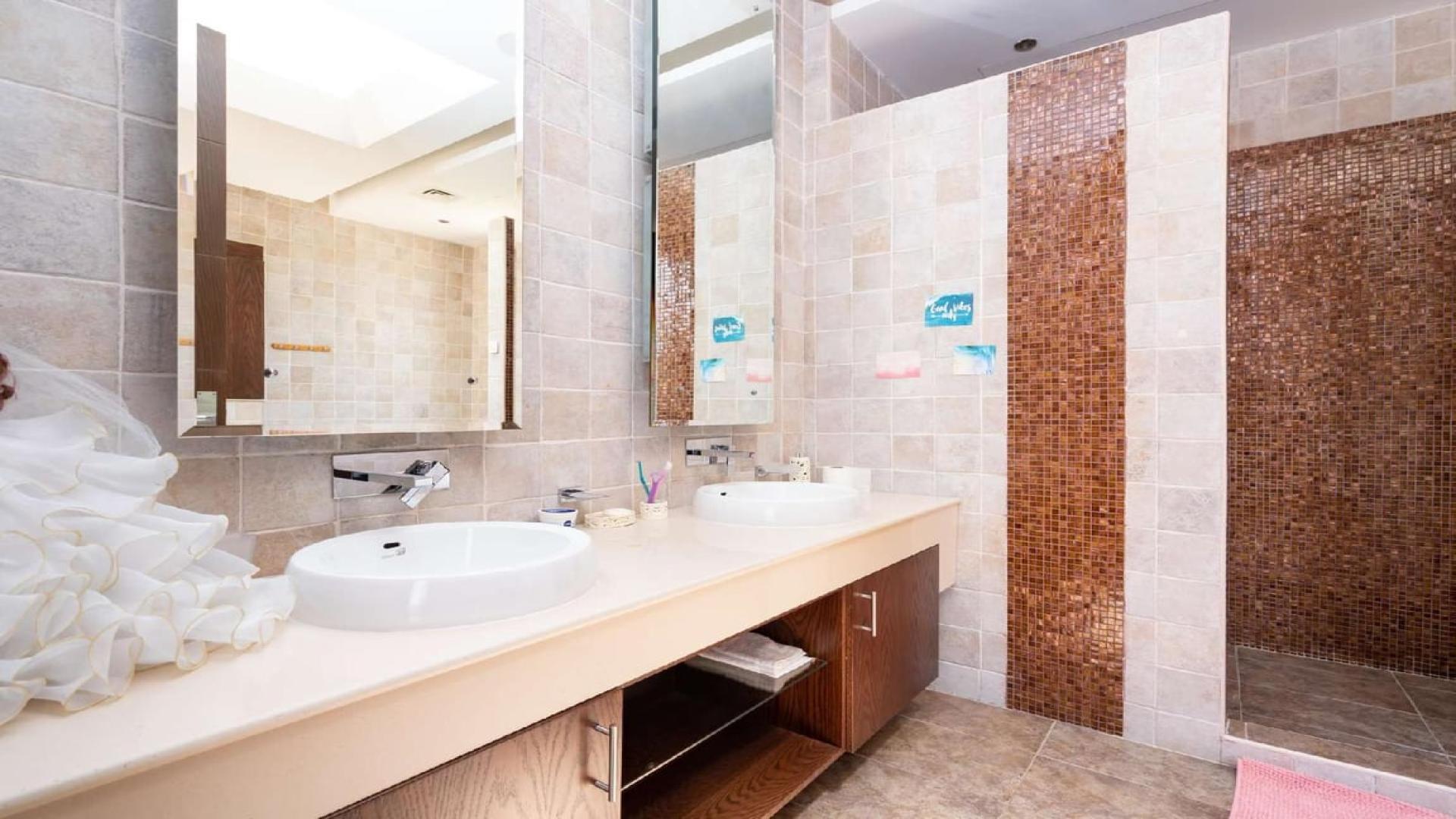 Luxurious living room in Al Barari villa with blue sofas and elegant decor