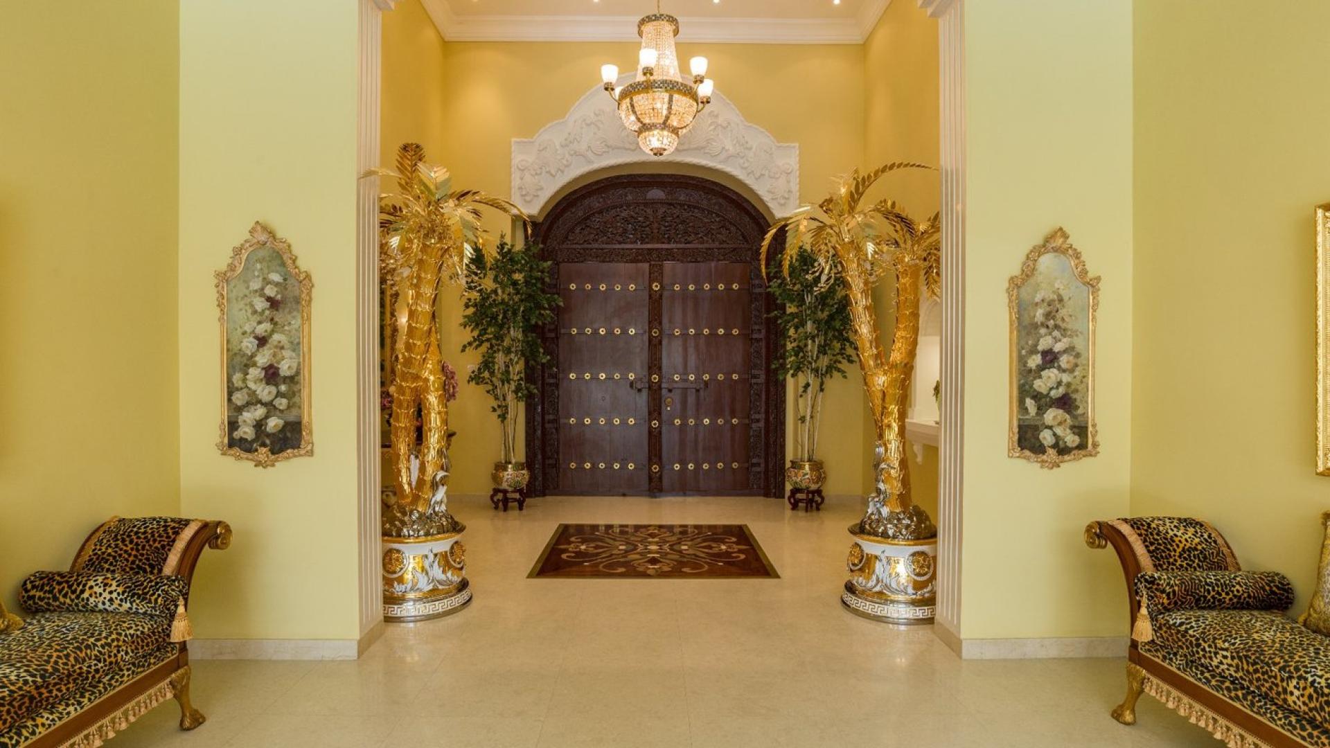 Luxurious villa entrance in Al Barsha with elegant Versace finishings and ornate decor