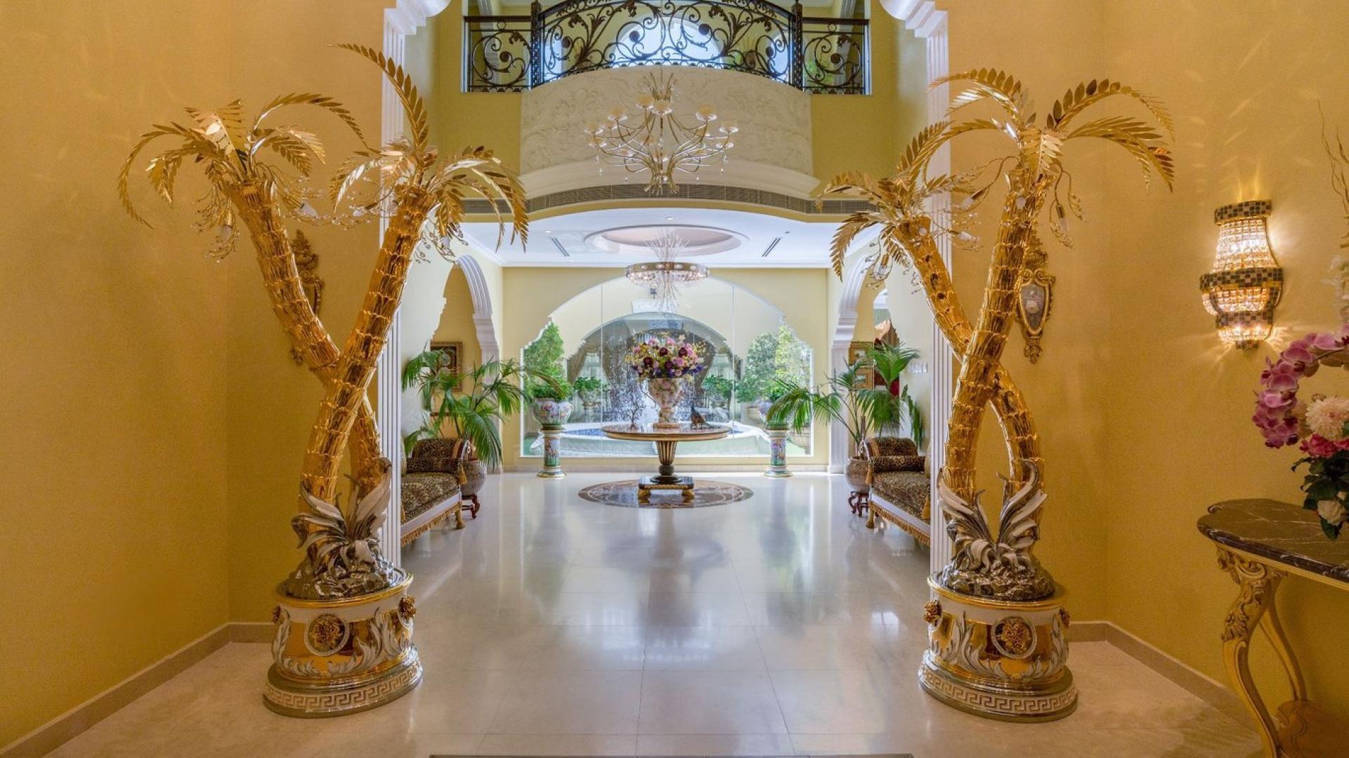 Luxurious Al Barsha villa entrance with elegant Versace finishings and grand chandelier display