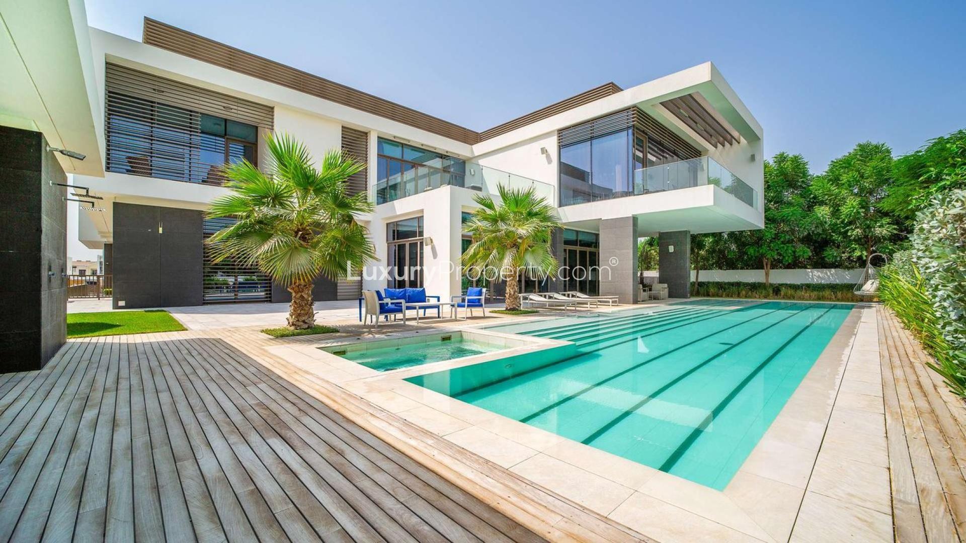 Luxurious villa with pool in District One, MBR City, featuring modern architecture and palm trees