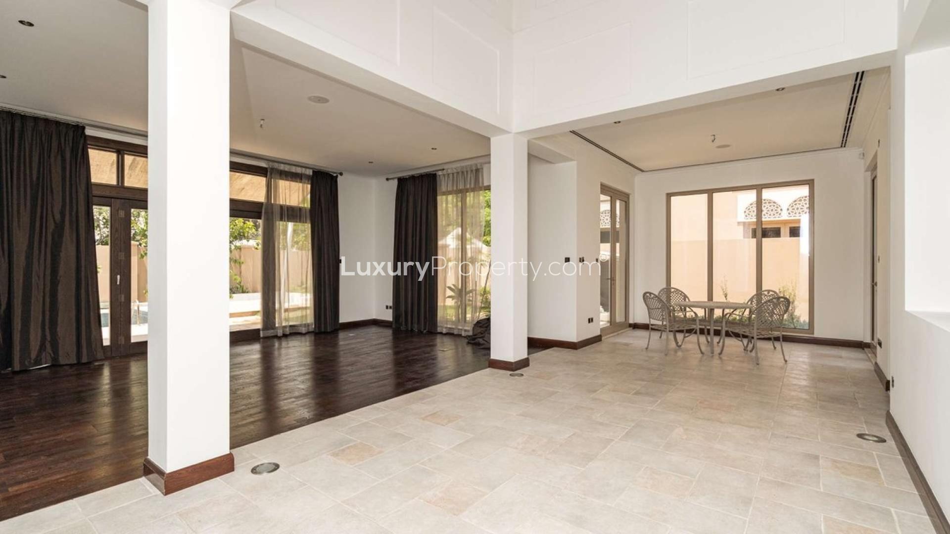 Spacious living room in A Type Villa, Dubai Hills Estate, with garden view through large windows