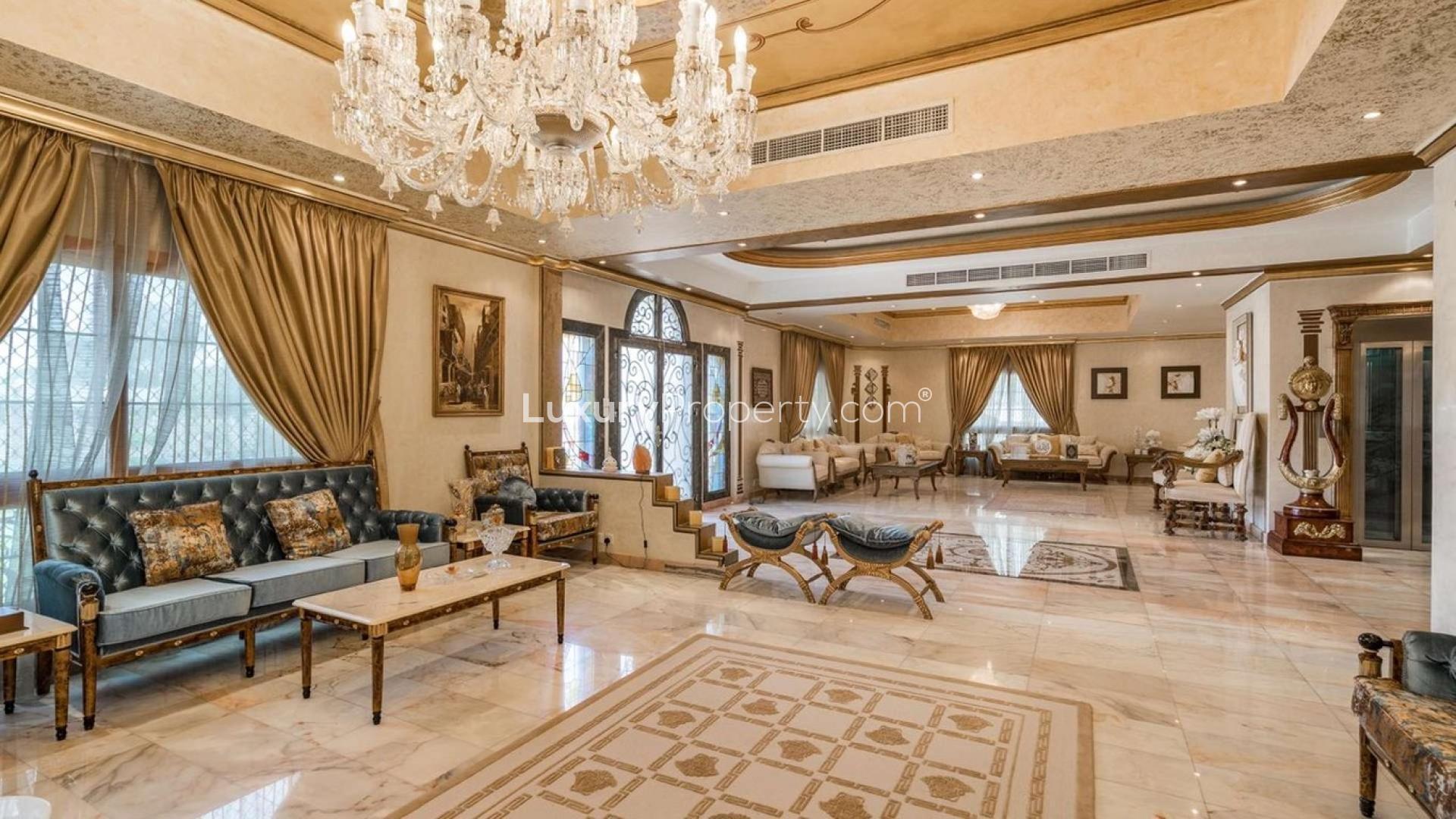 Luxurious villa living room with elegant decor, chandeliers, and plush seating in Al Wasl