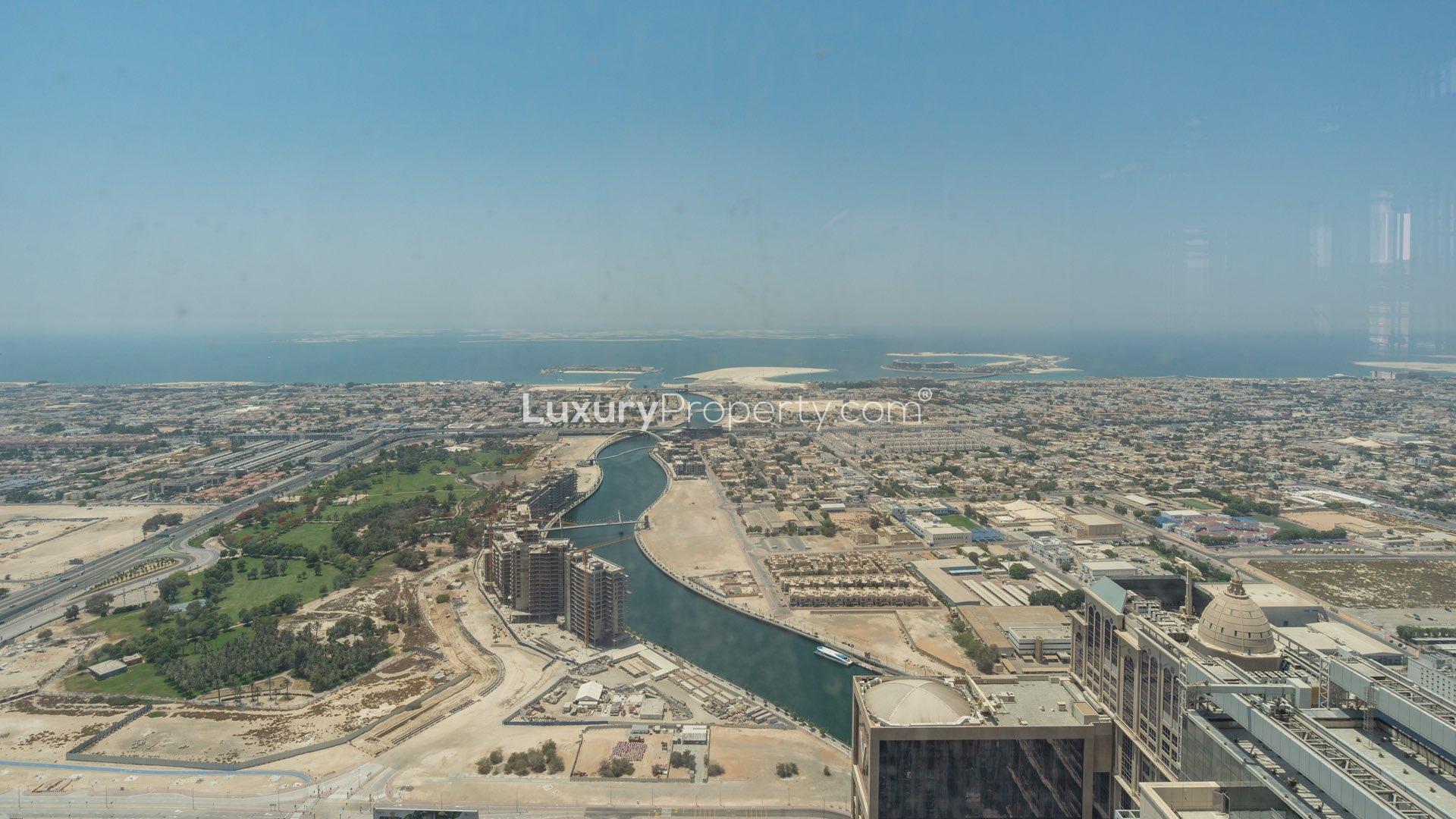 "Spacious terrace view at luxurious Amna Tower penthouse, Al Habtoor City, Business Bay.",Aerial view from Amna Tower penthouse, showcasing Dubai skyline and waterfront scenery