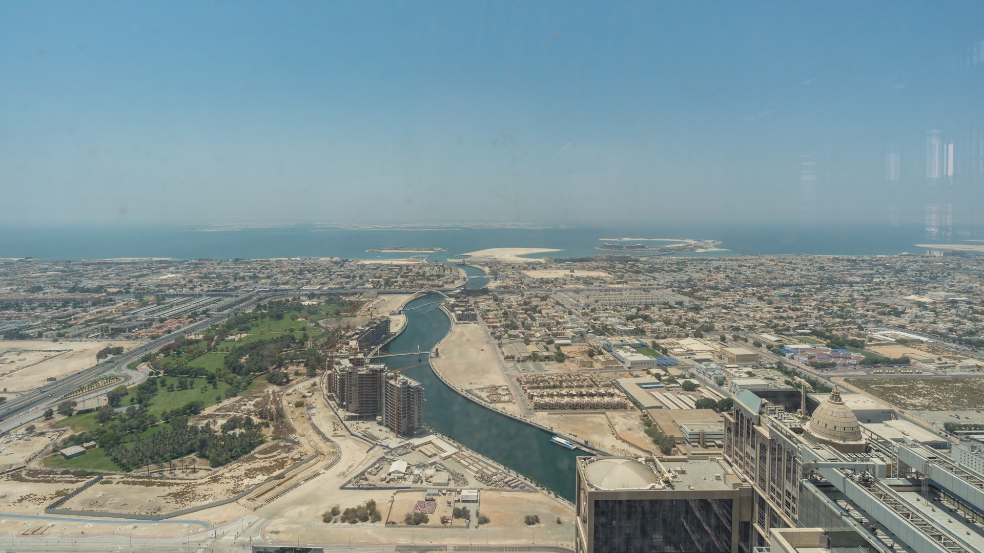 "Spacious terrace view at luxurious Amna Tower penthouse, Al Habtoor City, Business Bay.",Aerial view from Amna Tower penthouse, showcasing Dubai skyline and waterfront scenery