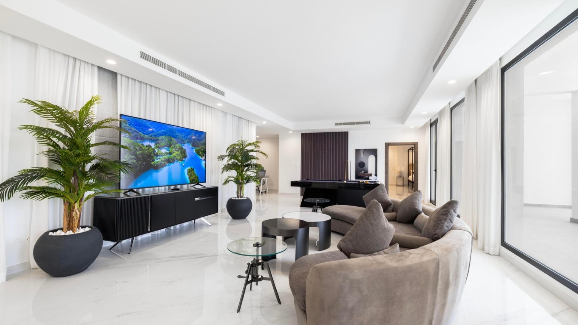 "Ultra-luxury 7-bedroom villa with pool, Palm Jumeirah waterfront, Signature Villas community.",Luxurious living room in 7-bedroom villa for rent, Palm Jumeirah waterfront, Signature Villas