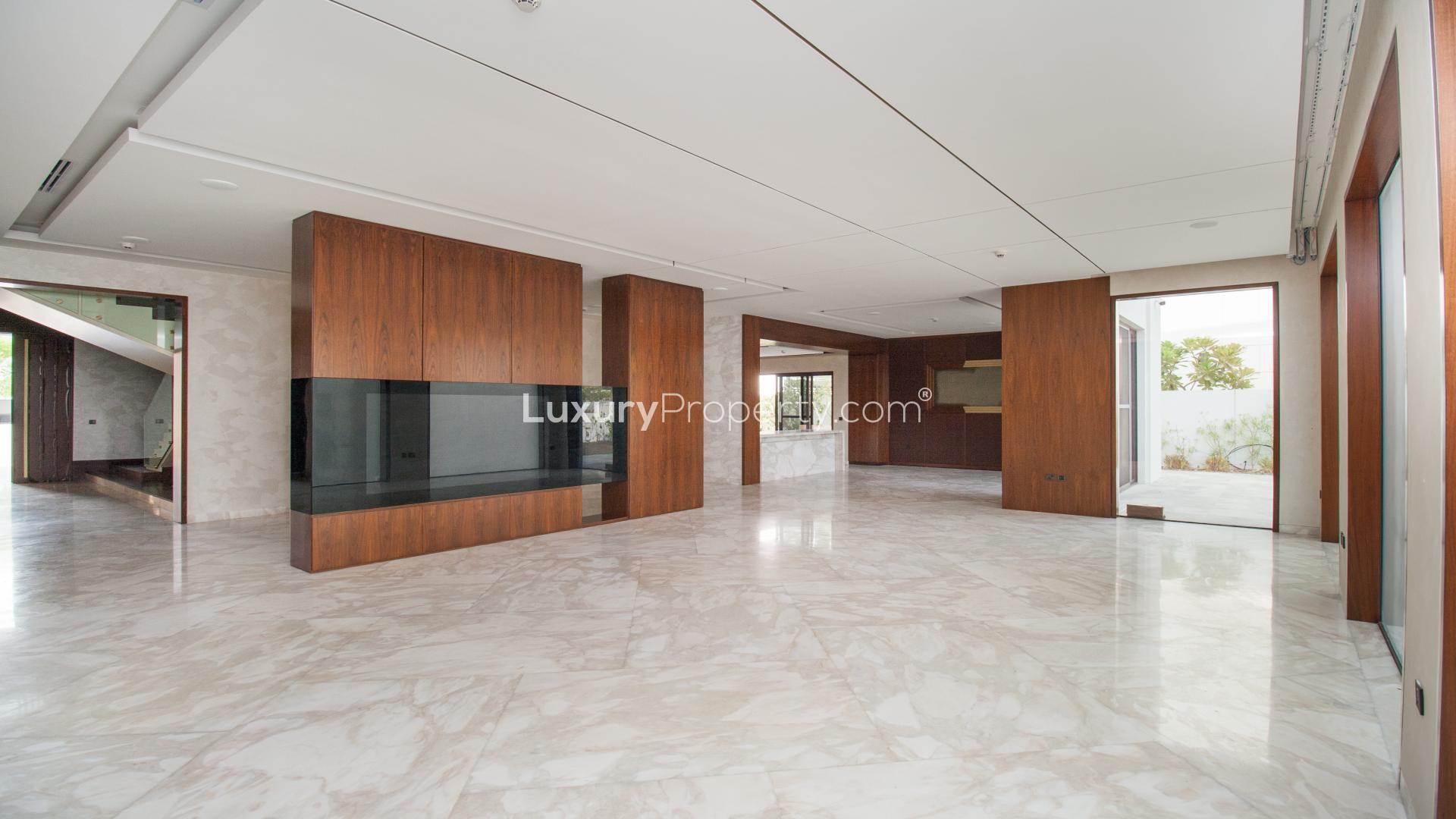 Spacious interior of luxury villa in District One, marble flooring and wooden accents