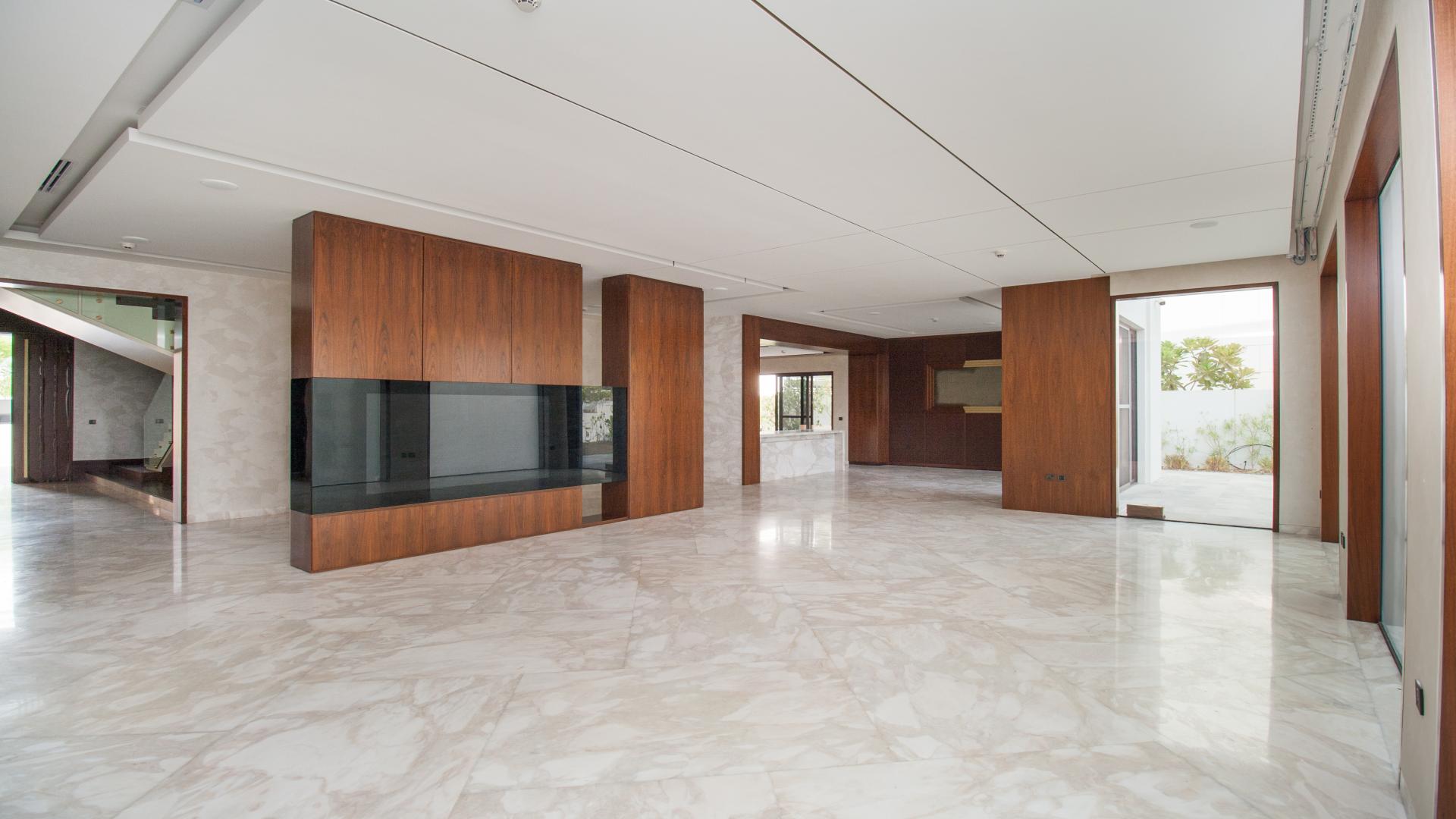Spacious interior of luxury villa in District One, marble flooring and wooden accents