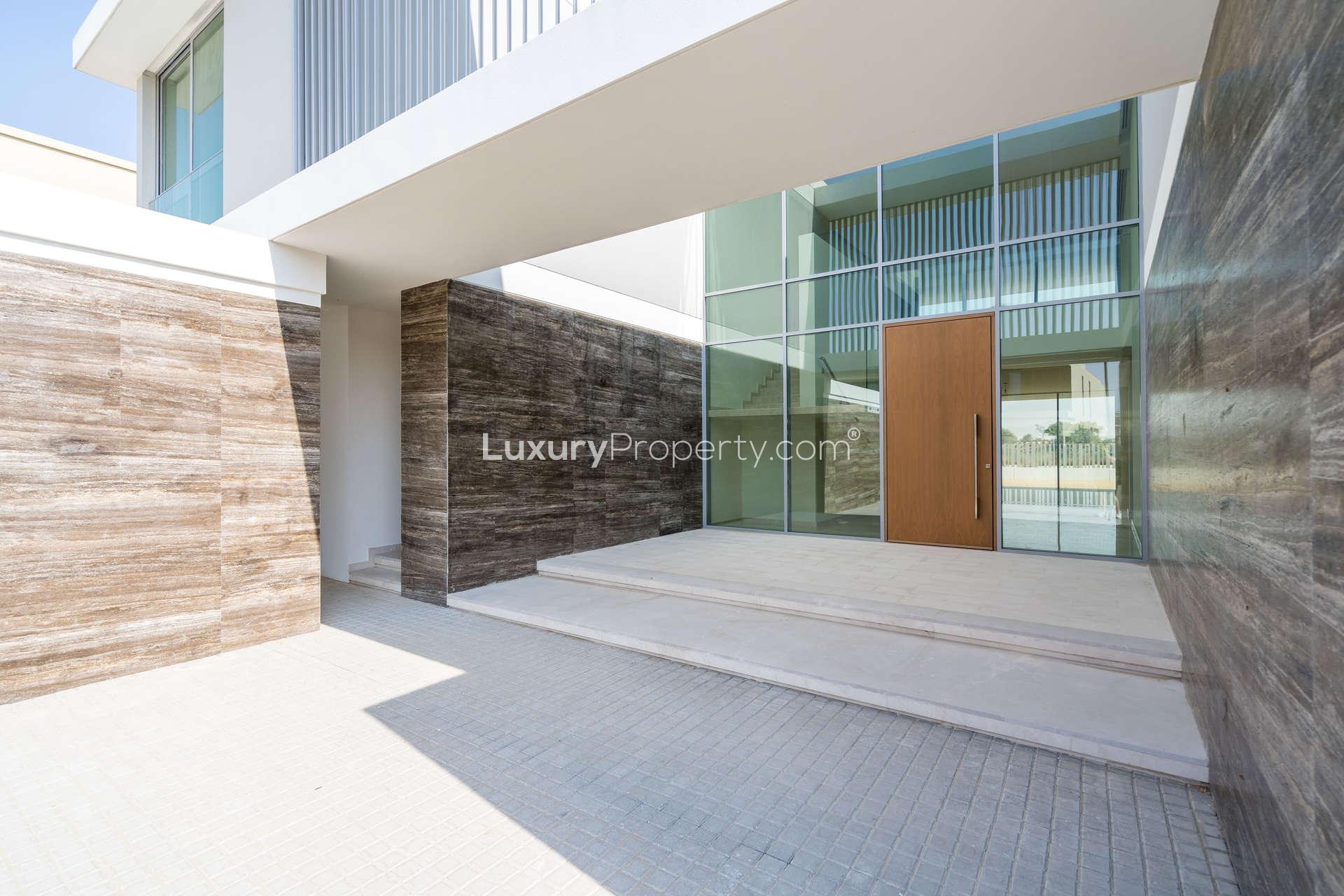 "Spacious balcony with golf course view in Fairway Vistas, Dubai Hills Estate villa.",Front entrance of brand new villa for rent in Dubai Hills Estate, Fairway Vistas