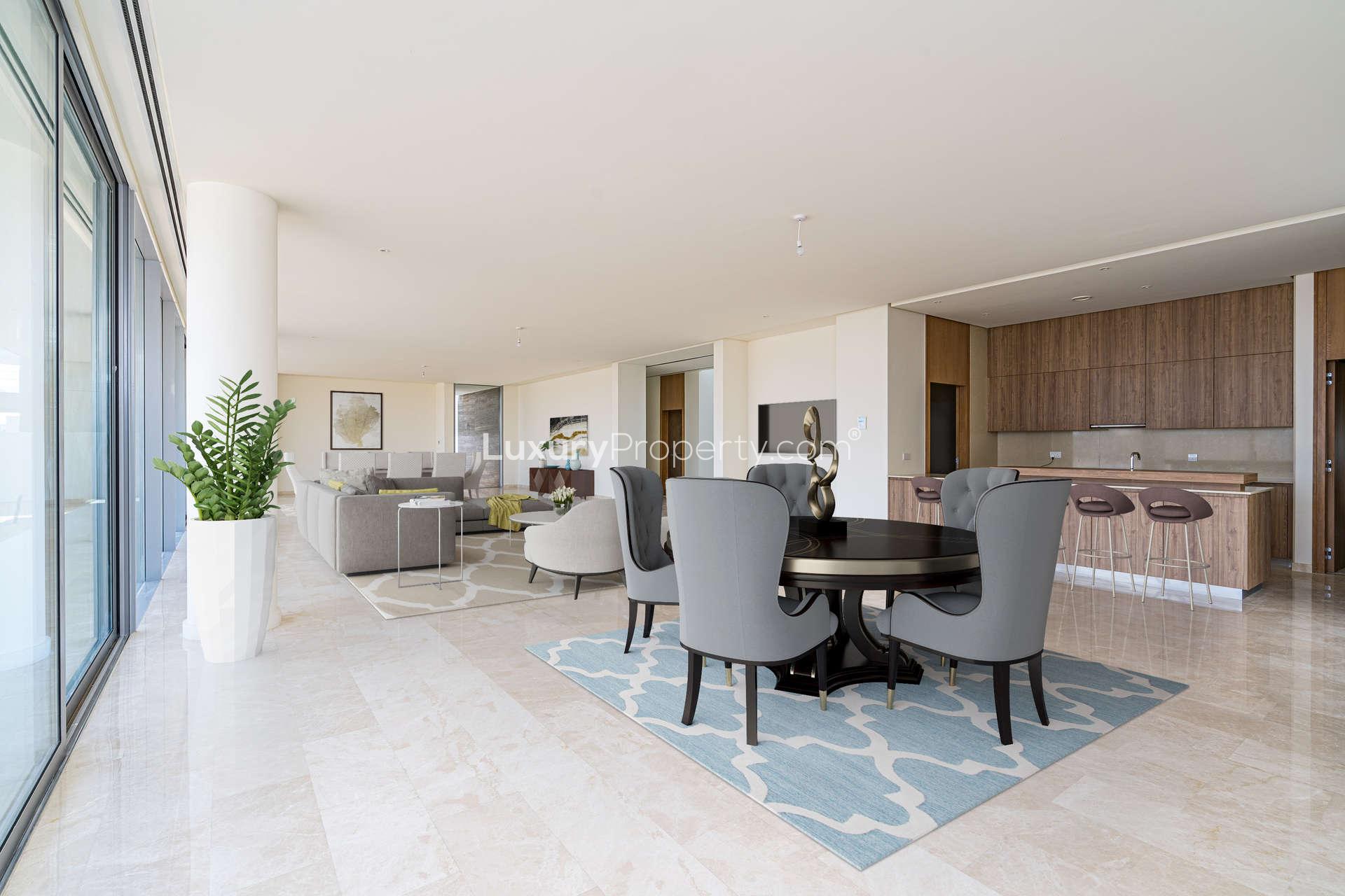 Luxurious open-plan living area in Dubai Hills Estate villa, featuring modern furniture and kitchen