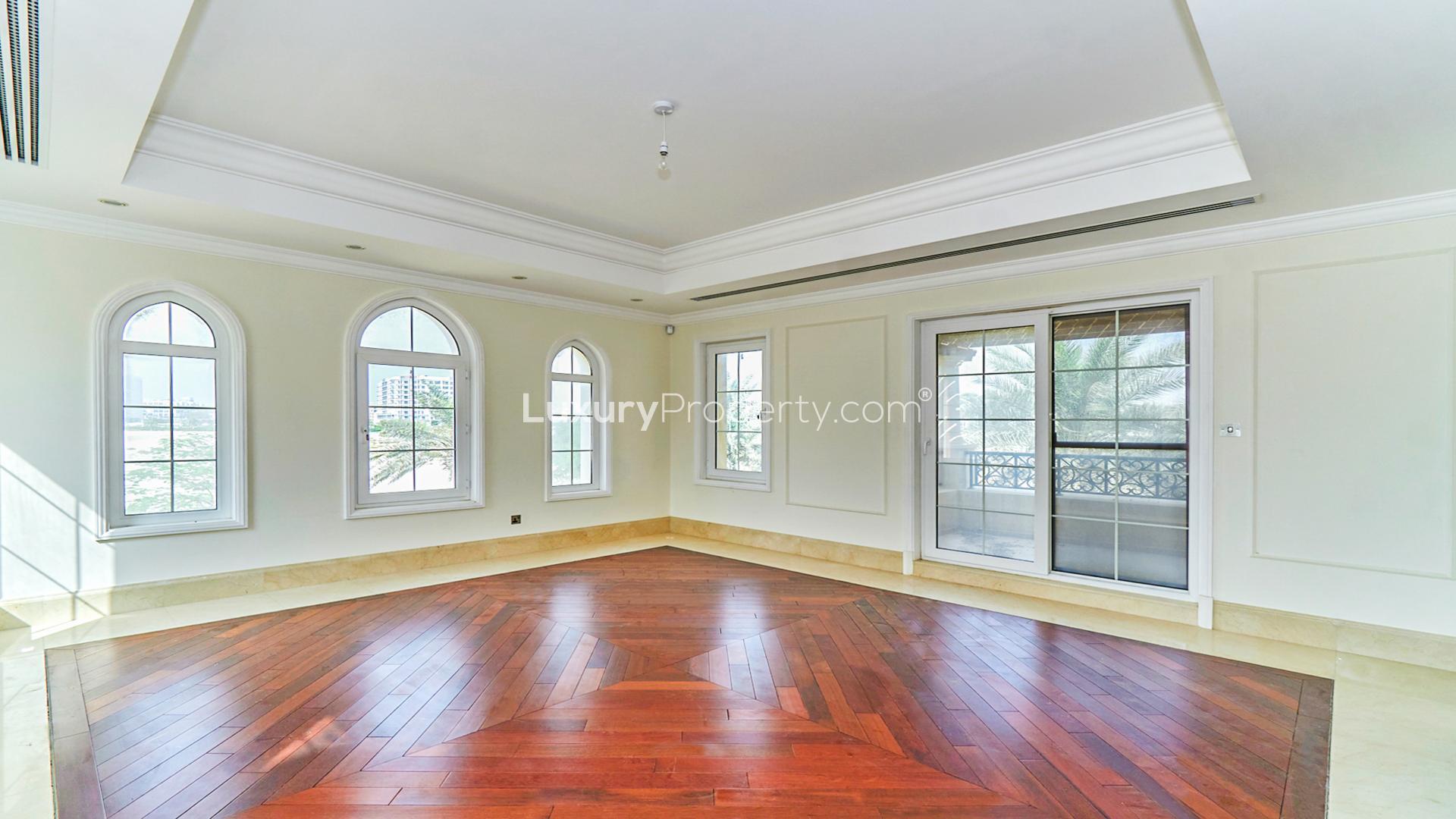 Spacious living area in 7-bed villa at Arabian Ranches, featuring elegant flooring and windows