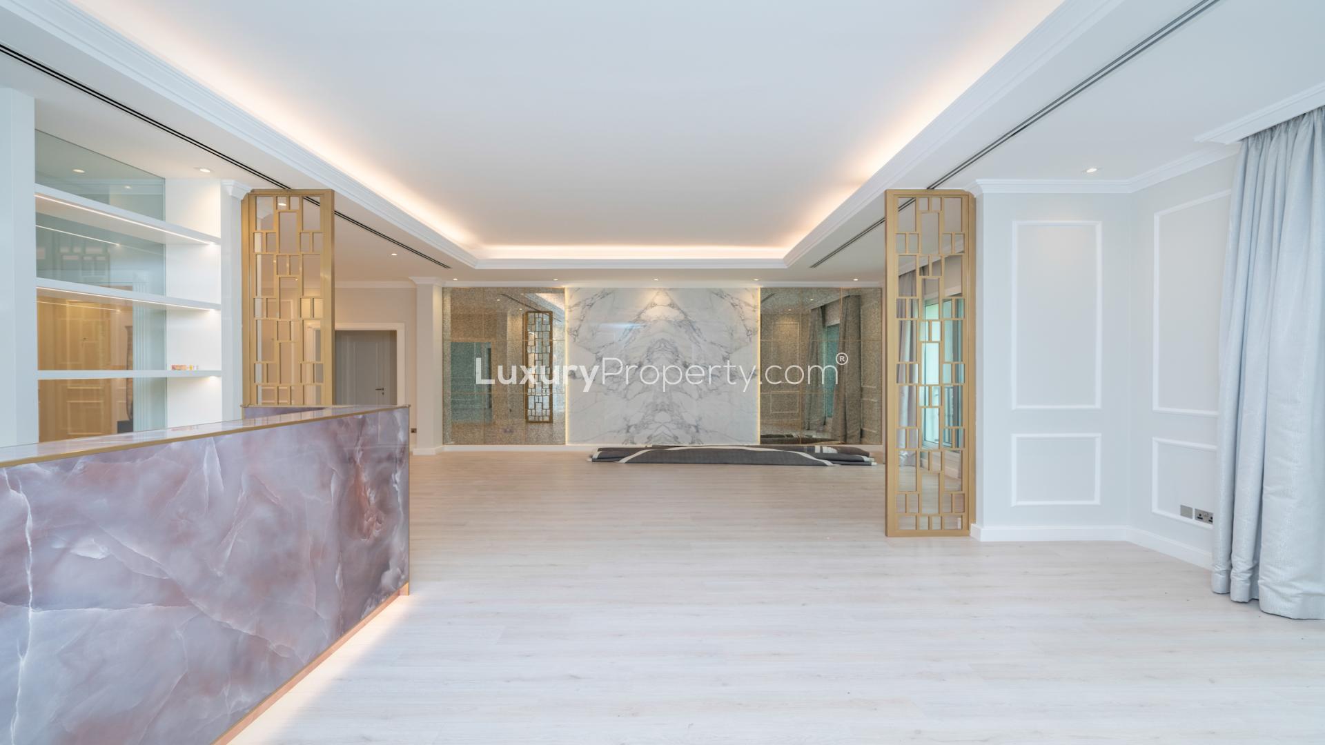 Luxurious 7-bedroom villa exterior with lush greenery in Emirates Hills, Sector E