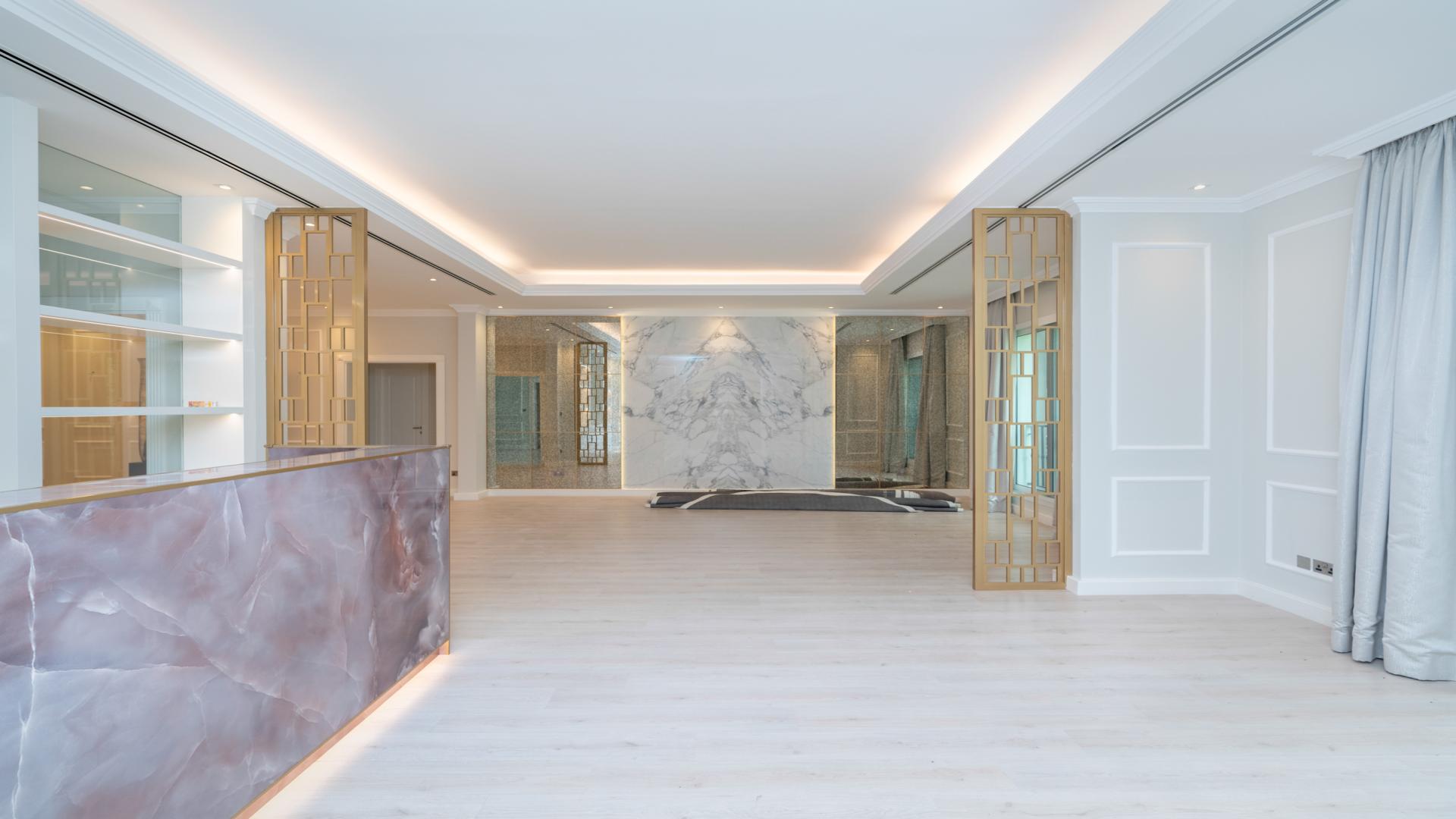 Luxurious 7-bedroom villa exterior with lush greenery in Emirates Hills, Sector E