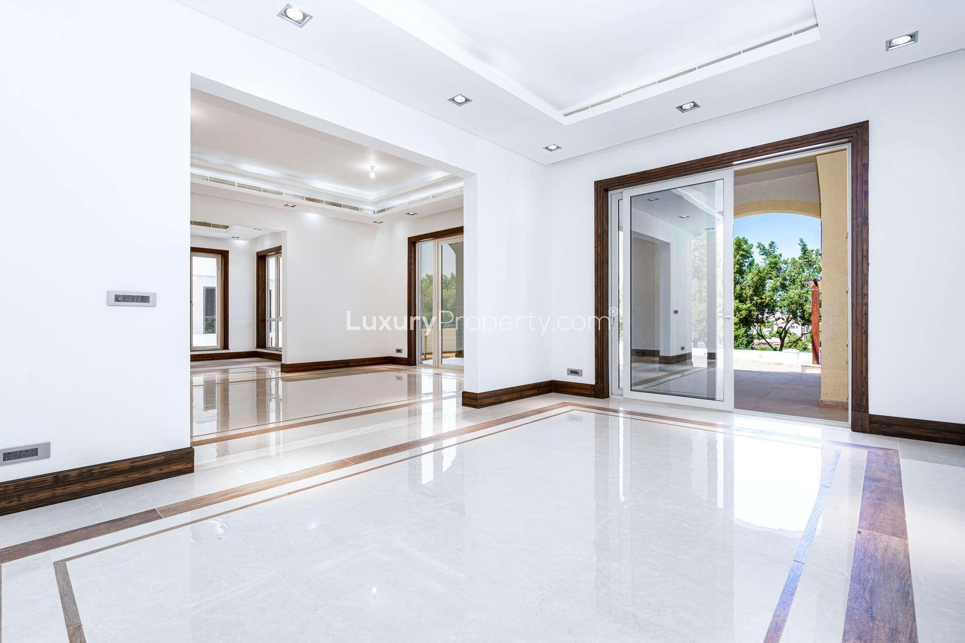 "Spacious open-plan living area in luxury villa, Jumeirah Golf Estates, Earth community.",Luxury villa interior with marble floors, large windows, Jumeirah Golf Estates, Earth community
