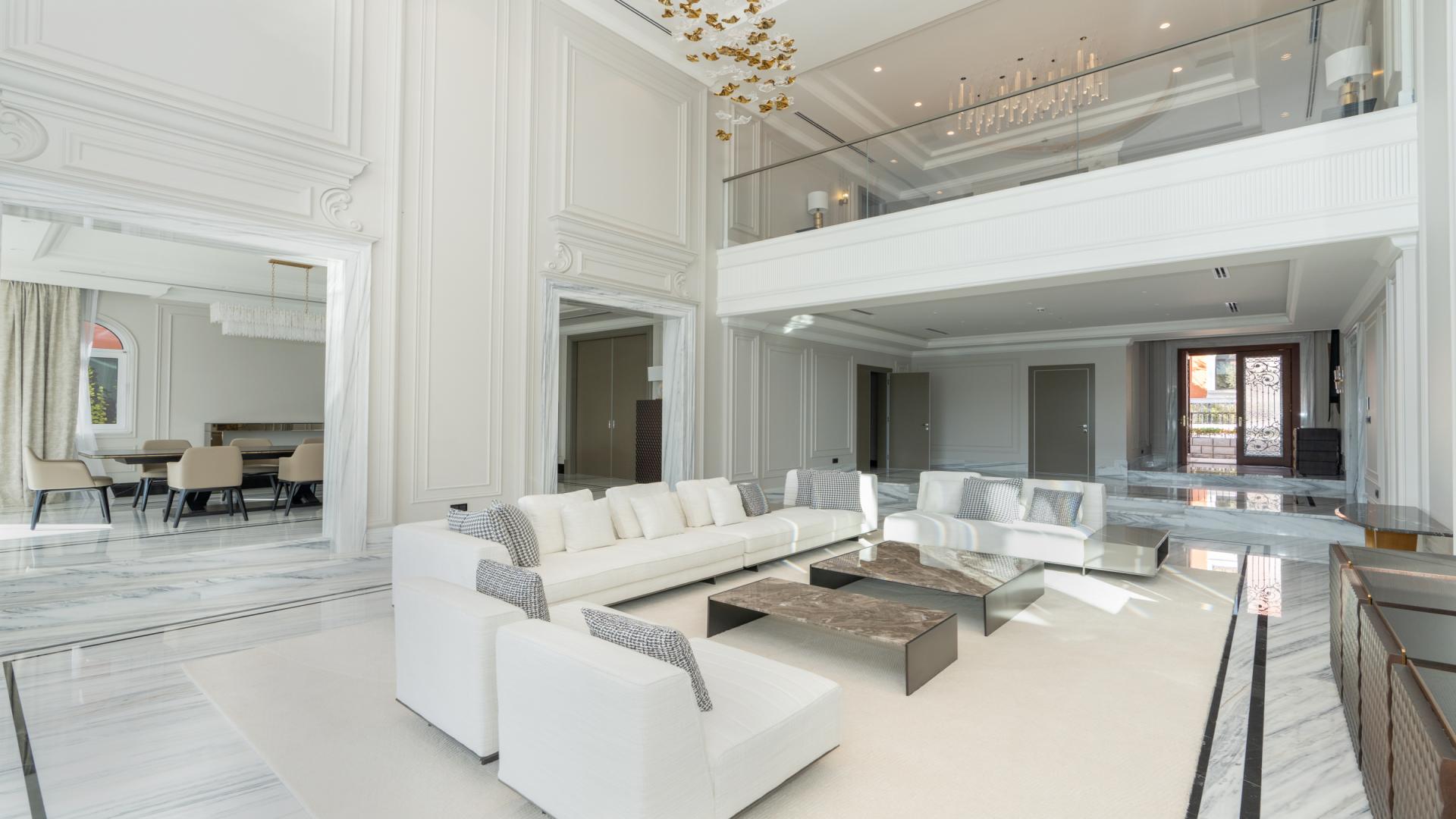 Luxurious living room in XXII Carat Villa, Palm Jumeirah, with elegant decor and high ceilings
