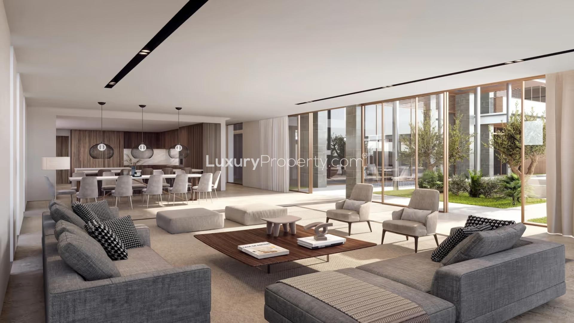 "Luxurious beachfront villa with pool on Al Reem Island, Abu Dhabi, for sale.",Luxurious living room in Reem Hills beachfront villa, Abu Dhabi, with modern decor and garden view