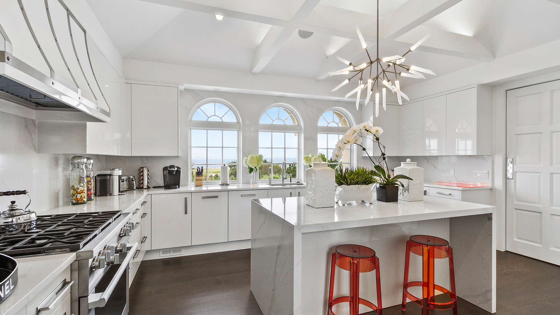 Elegant living room in luxury 7-bedroom villa, Southampton, featuring large windows and stylish decor