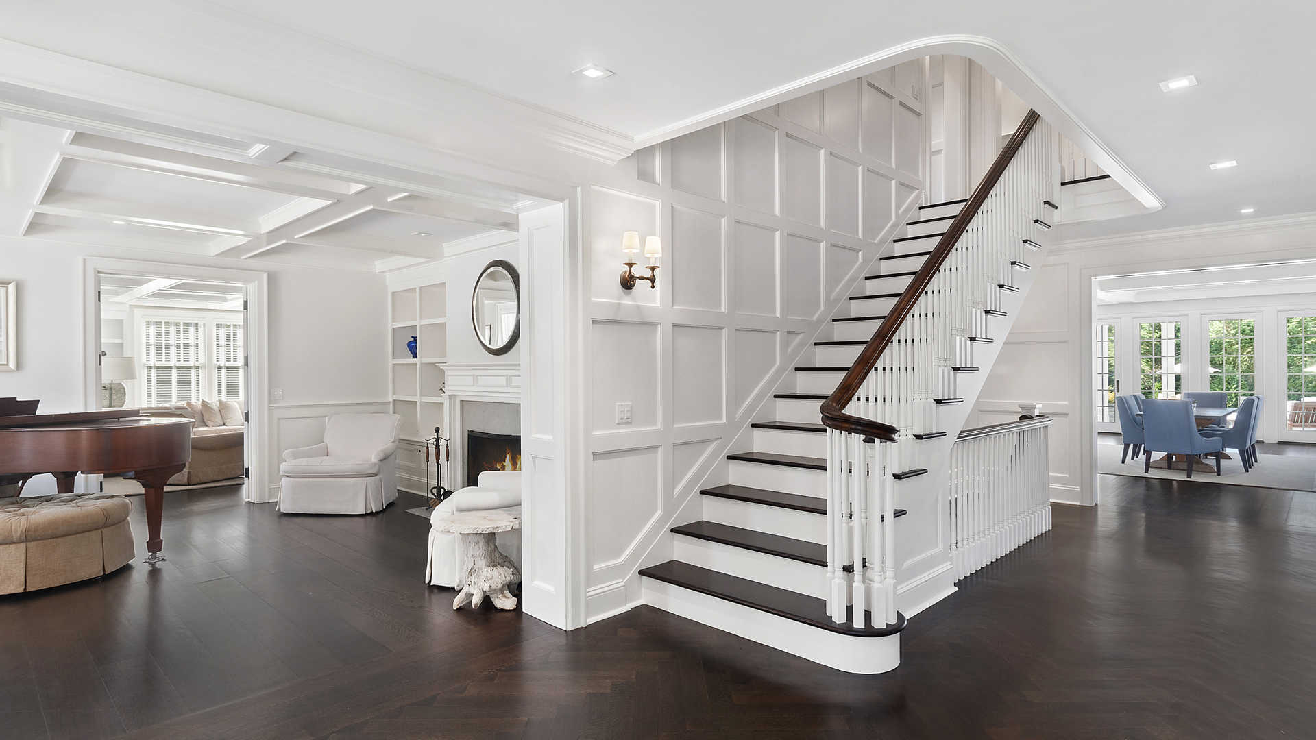 Aerial view of luxury villa with pool in Hamptons, NY, surrounded by lush greenery