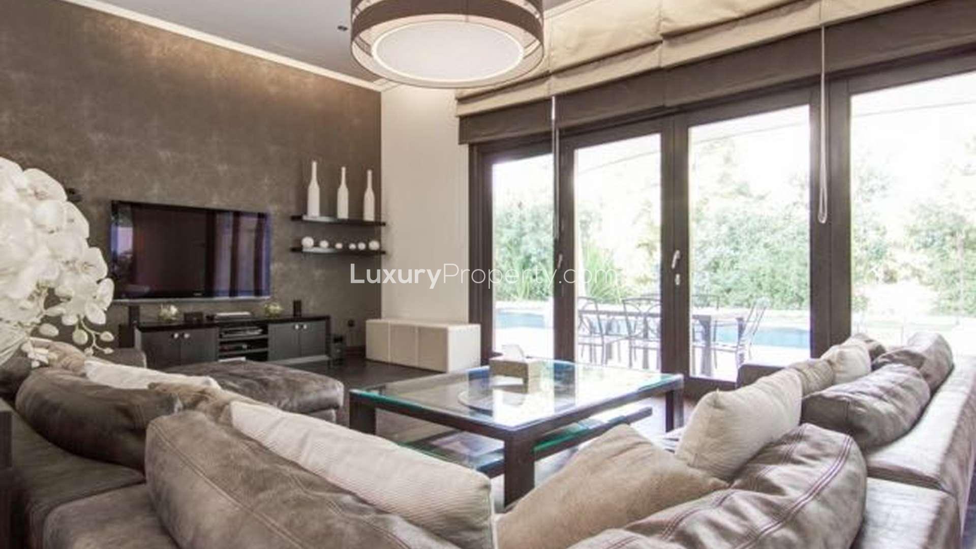 Luxurious Al Barari villa with stunning pool and modern patio furniture for rent