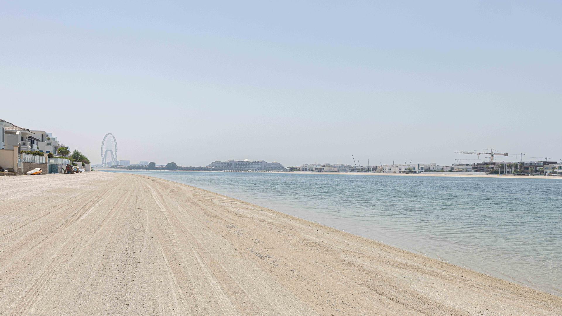 Spacious living room with large windows and water views in Palm Jumeirah villa
