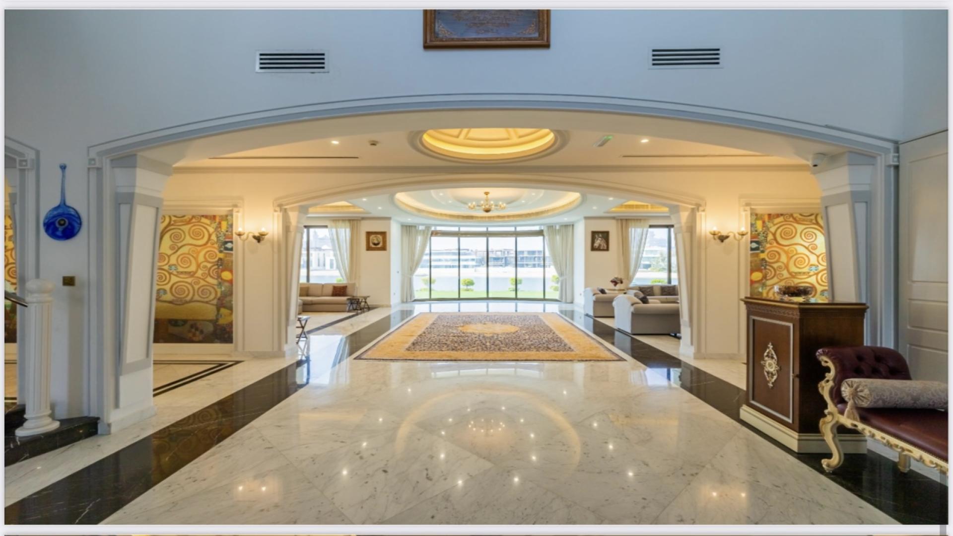 Luxurious living room in Palm Jumeirah mansion with elegant decor and waterfront view