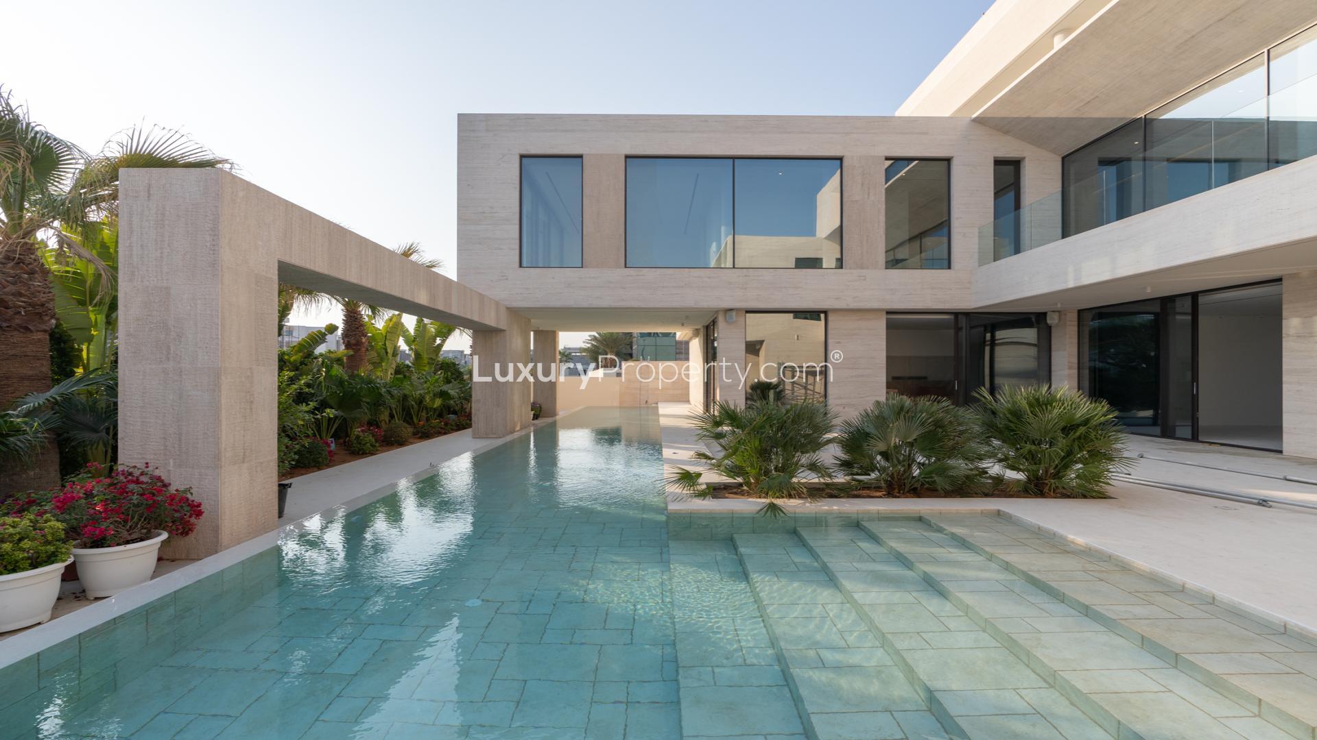 Luxurious villa with modern design, private pool, and lush greenery in Pearl Jumeirah