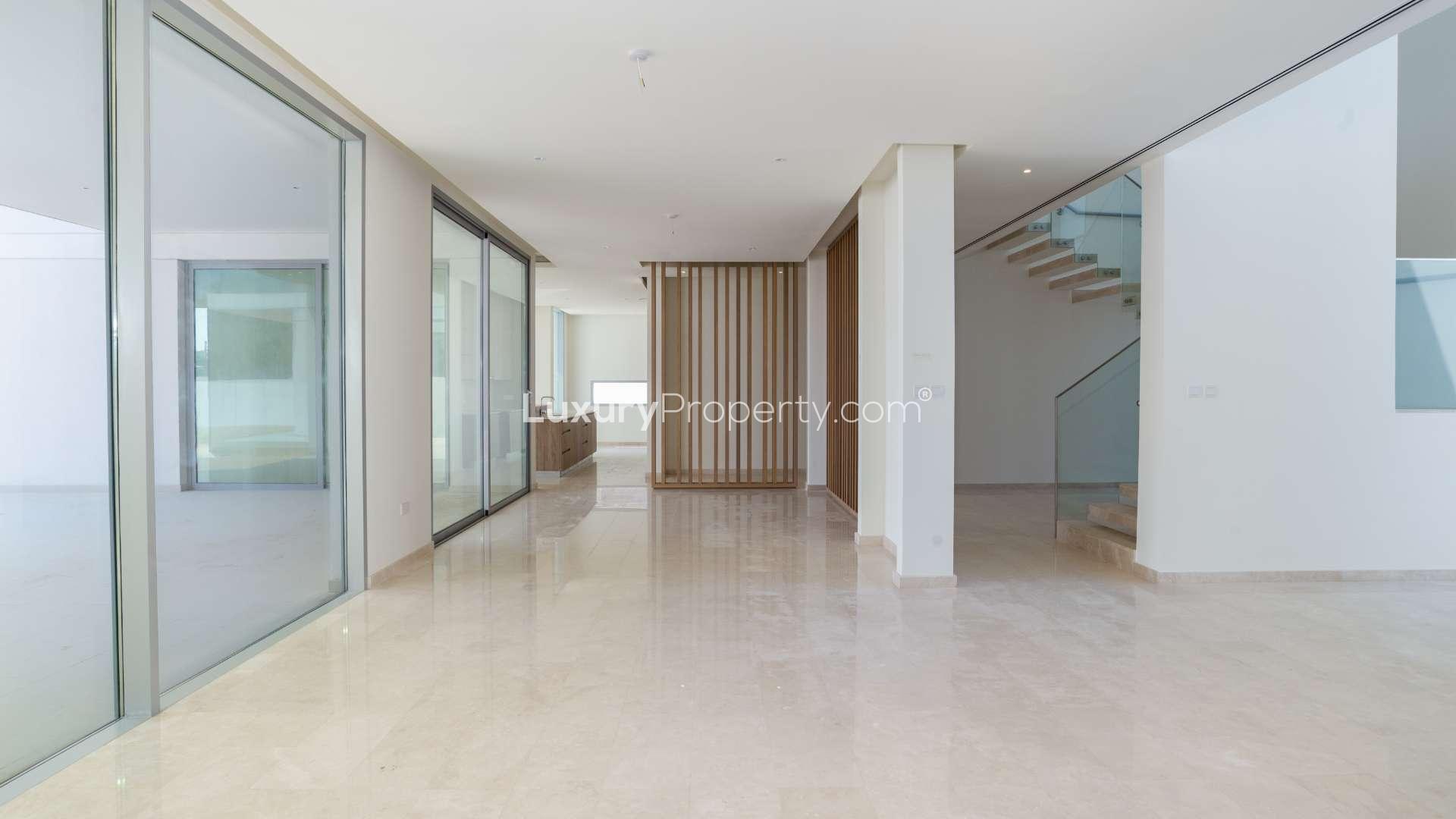 Spacious kitchen with island in 7-bedroom Dubai Hills Estate villa, natural light flooding in