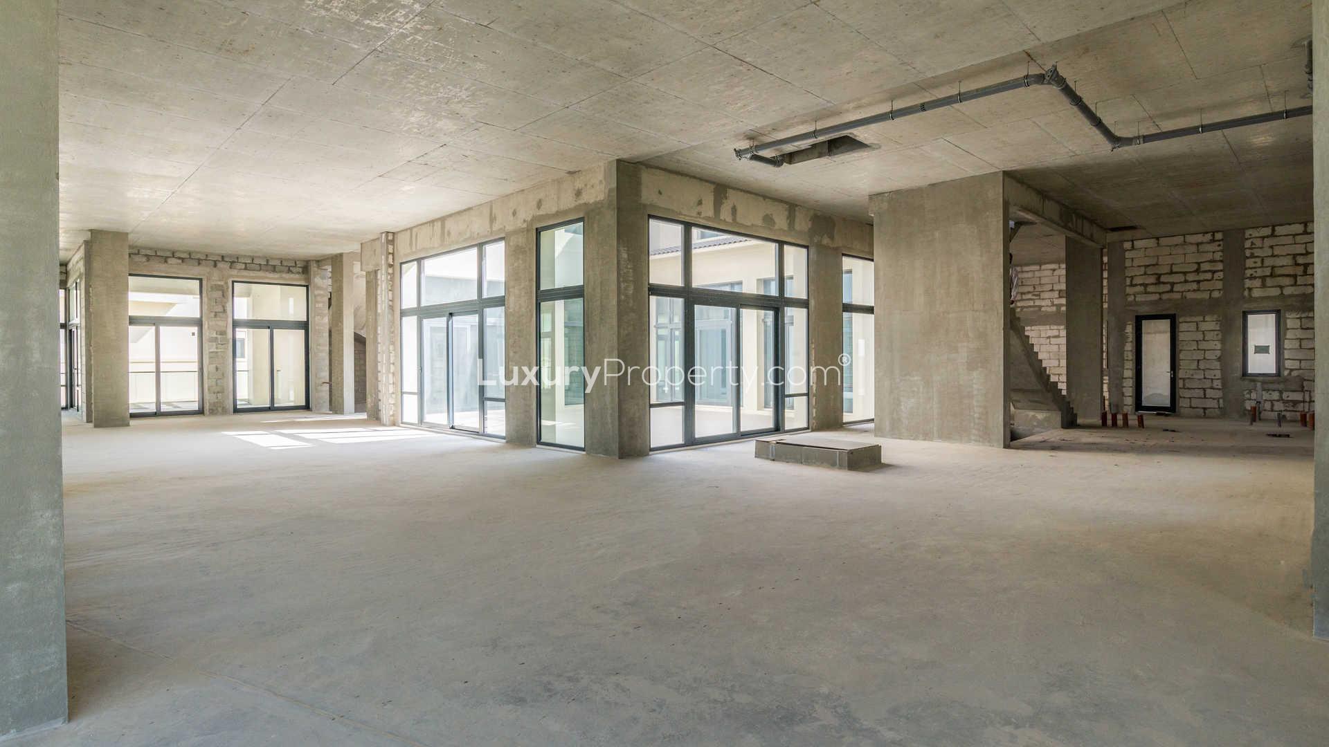 Unfinished interior of 7-bed villa in Dubai Hills Estate with large windows and staircase