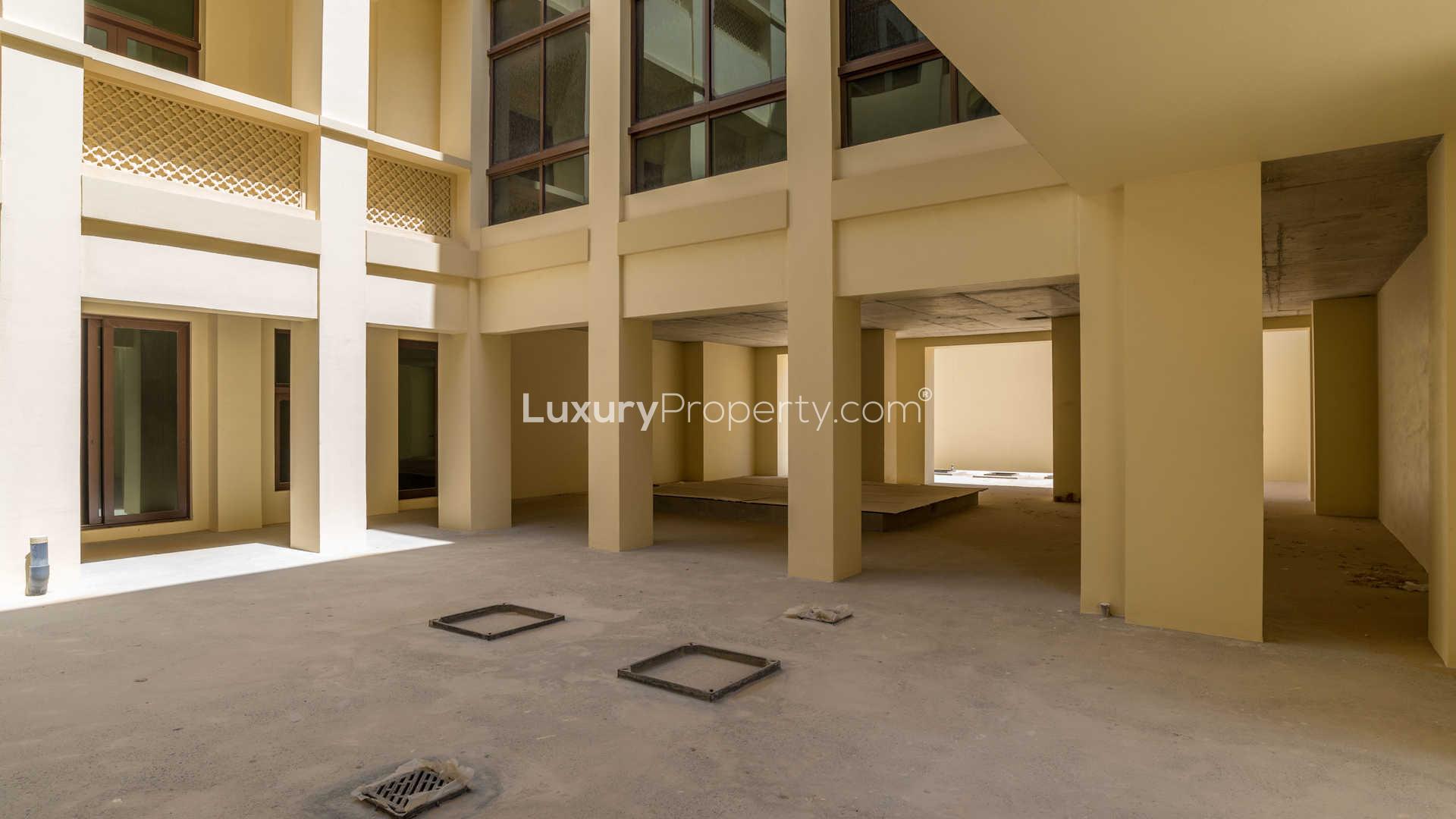 Spacious unfinished interior of 7-bedroom villa in Dubai Hills Estate, large windows and open space