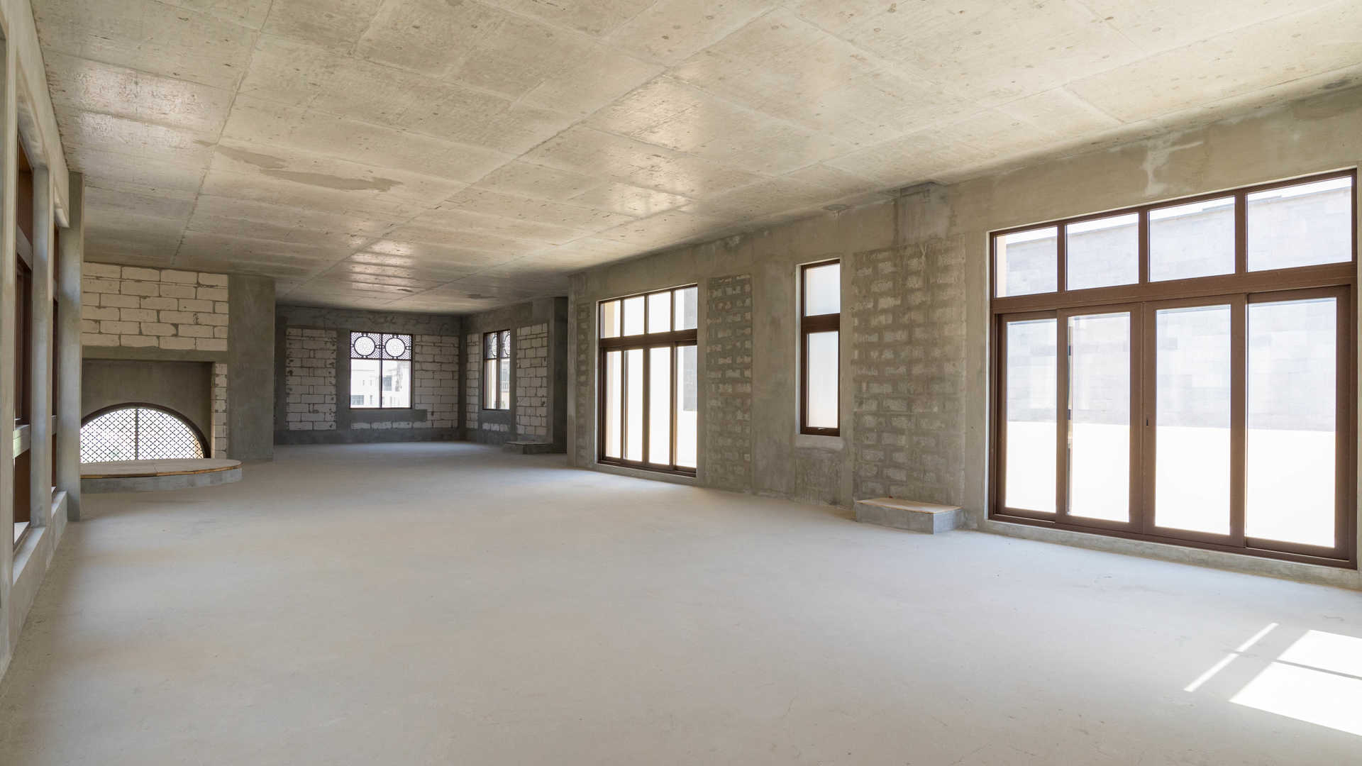 Unfinished interior of 7-bedroom villa in Dubai Hills Estate, showcasing open layout and staircase