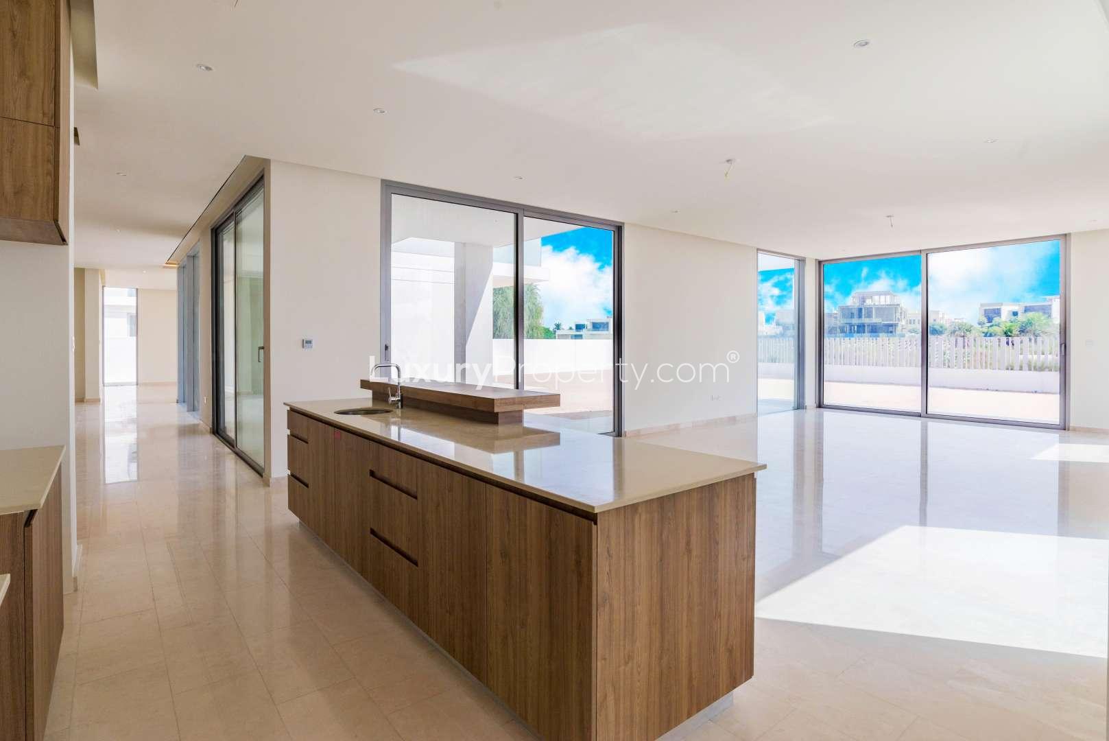 "Spacious living area in Dubai Hills Vista villa with modern design and natural light.",Modern kitchen in 7-bed villa, Dubai Hills Vista, with spacious layout and large windows