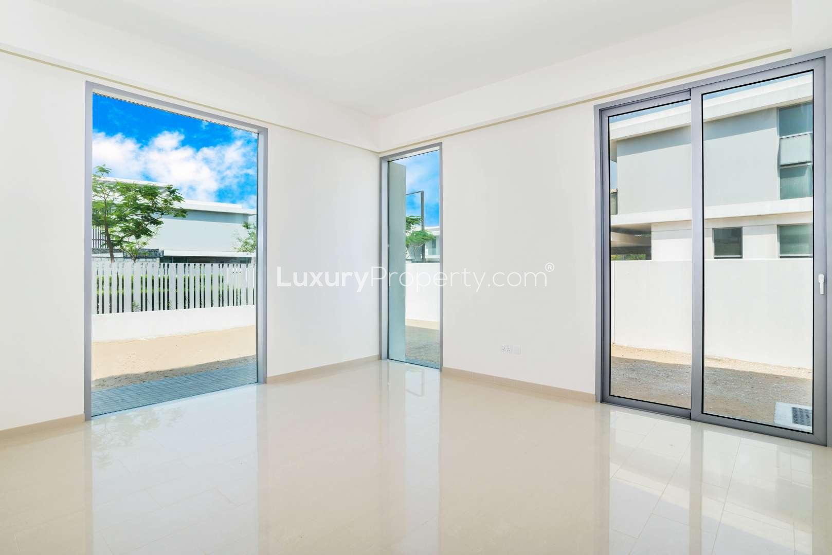 Bright interior of Dubai Hills Vista villa with large windows and garden view