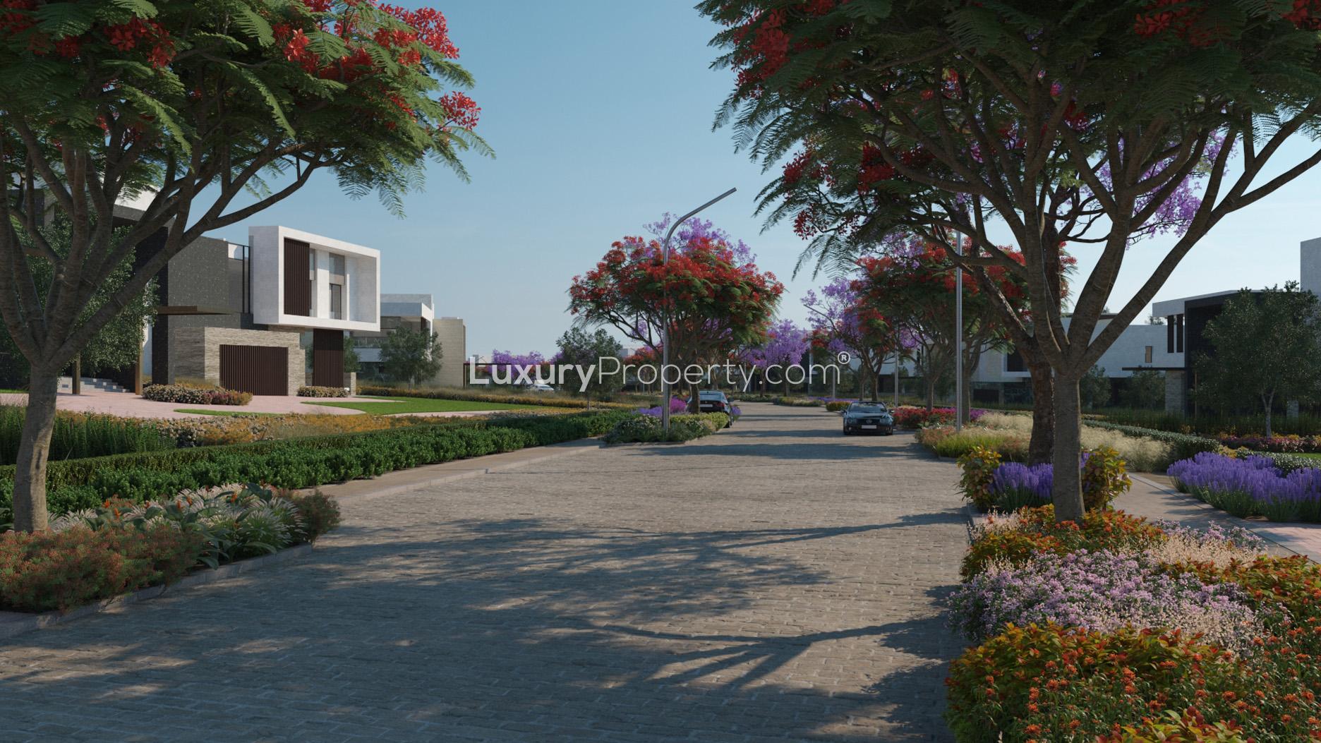Luxurious villa community street view in Eighteen, Islamabad with landscaped greenery