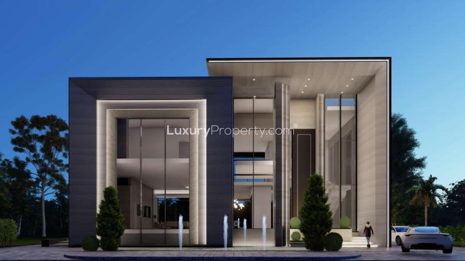 Modern villa exterior in Emerald Hills, Dubai Hills Estate, showcasing large glass windows and lighting